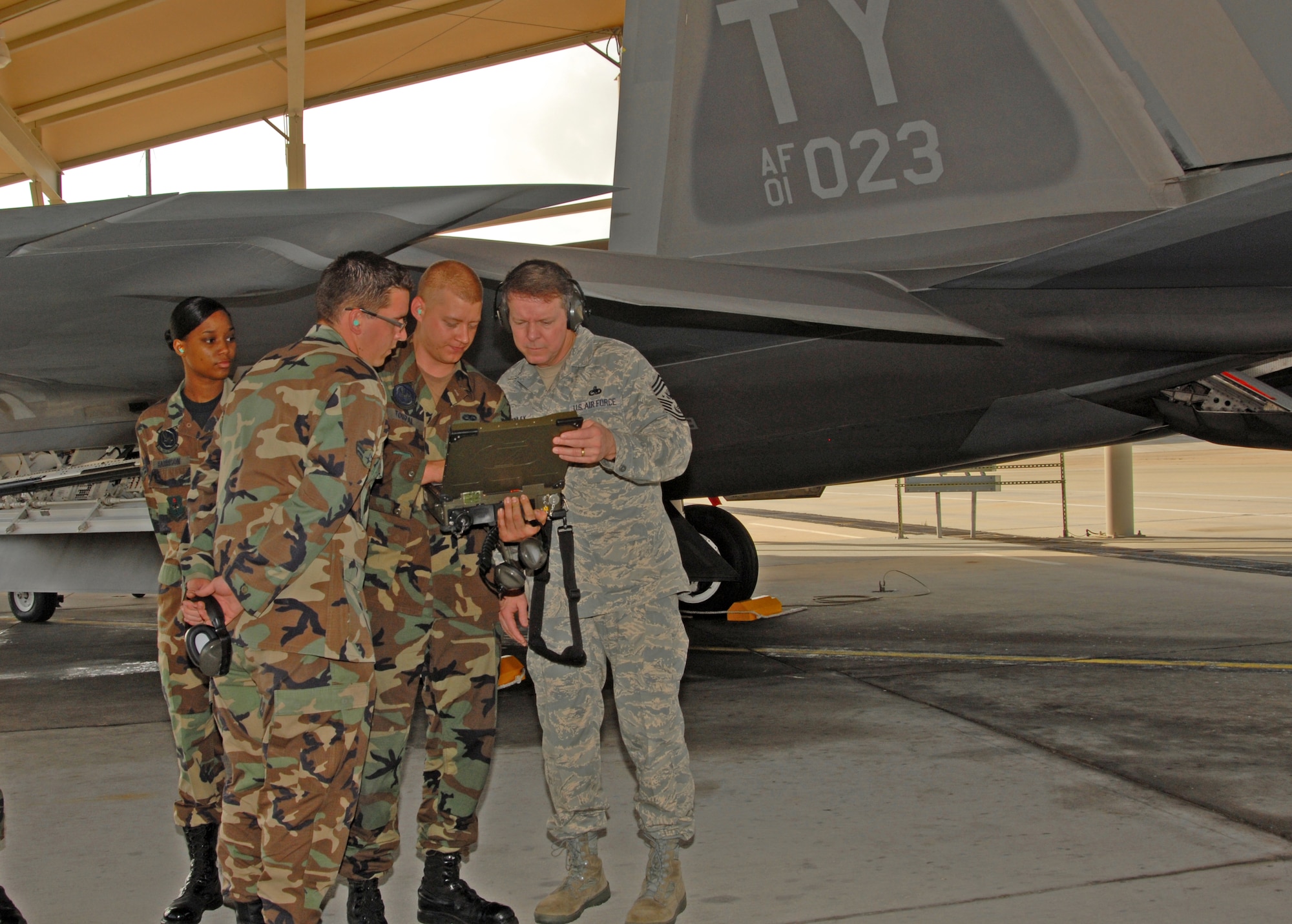 Airman 1st Class Austin Toupal, 43rd Aircraft Maintenance Unit assistant dedicated crew chief, shows Chief Master Sergeant of the Air Force Rodney J. McKinley the Miltope system for the F-22 Raptor. The chief had a chance to see the Raptor and visit with Airmen around the base during his two-day tour here last week.  (U.S. Air Force photo/Susan Trahan)
