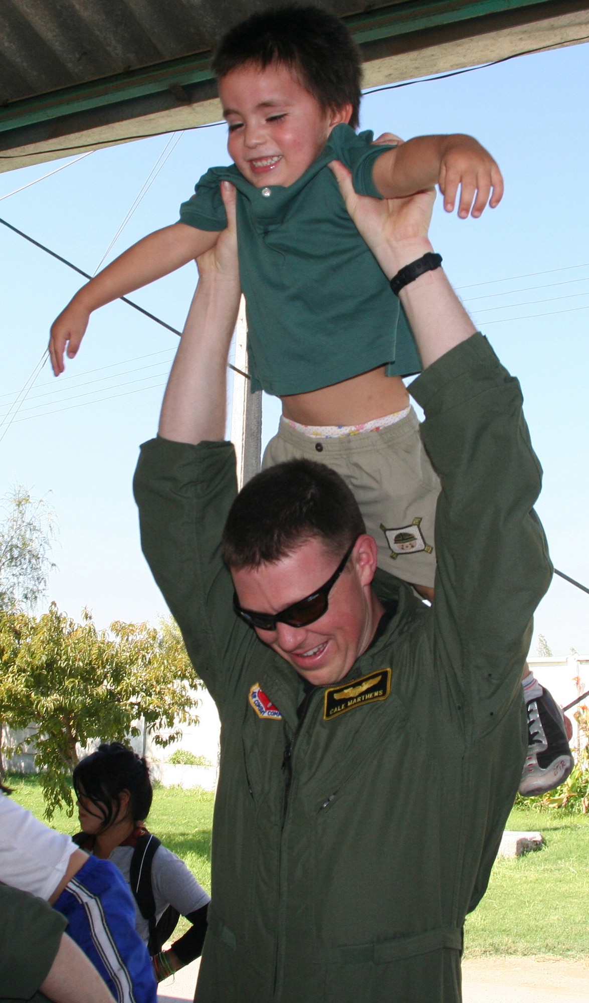 SANTIAGO, Chile – Capt. Cale Marthens, 391st Fighter Squadron, lifts up a Chilean orphan April 3 as part of an Air Forces Southern visit to Koinomadelfia Orphanage west of Santiago. Twenty Airmen here showcasing their aircraft at FIDAE, the largest airshow in South America, visited more than 30 toddlers at the orphanage and handed out toys, stickers and patches. (U.S. Air Force photo by/ 1st Lt. Candace Cutrufo)