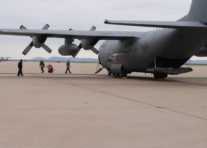 DYESS AIR FORCE BASE, Texas -- Two crew chiefs and a loadmaster standby for a pre-flight inspection, April 4. A team of crew chiefs must always be ready during a preflight, incase an engine does not start or there are any other problems (U.S. Air Force photo by Airman 1st Class Jennifer Romig)