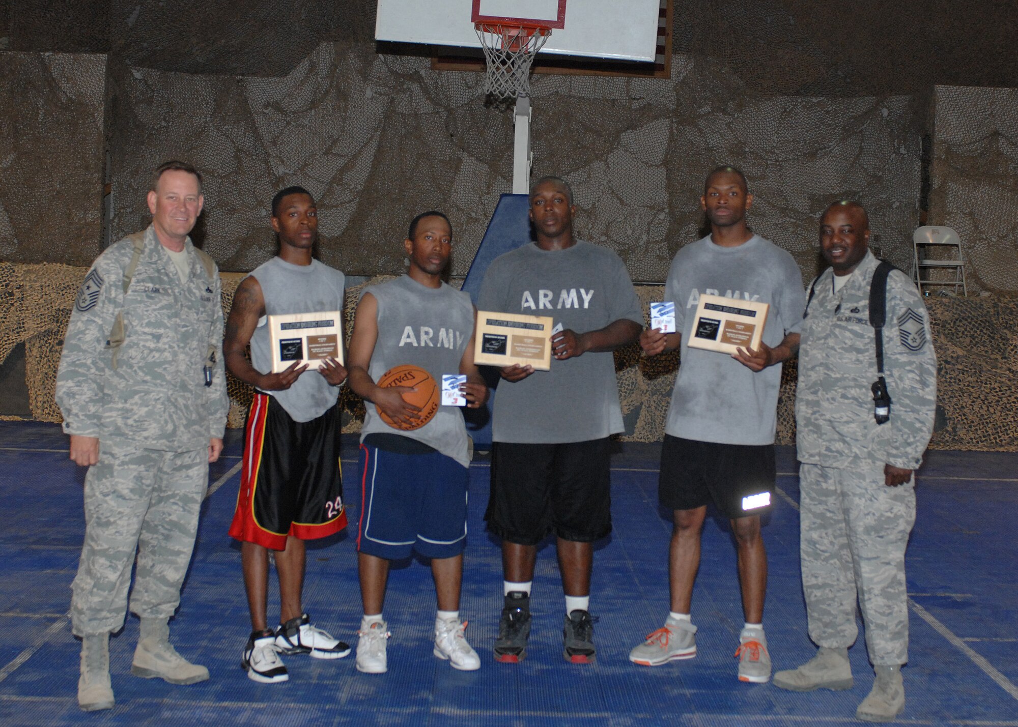 BAGRAM AIR BASE, Afghanistan - Members of the 24th Ordinance Battalion squad pose for a photo with their $30 gift cards and plaques with 455th Air Expeditionary Wing Command Chief (left) Chief Master Sgt. Ray Clark and 455th Expeditionary Mission Support Squadron superintendent Chief Master Sgt. Christopher L. Goosby. The team won the 'March Madness' 3-on-3 basketball tournament sponsored by the 455th Expeditionary Services Squadron. (U.S. Air Force Air Force photo by Master Sgt. Demetrius Lester)