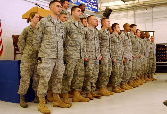 ANDREWS AIR FORCE BASE, Md. -- Members of the 459th Security Forces Squadron listen to kudos on stage during "Tribute to Troops," an event hosted by the 459th Mission Support Flight to thank returning troops for their various deployments during the last year. The event was emceed by Senior Airman Patrick Stout of the 69th Aerial Port Squadron. (U.S. Air Force photo/Senior Airman Ashley Crawford)