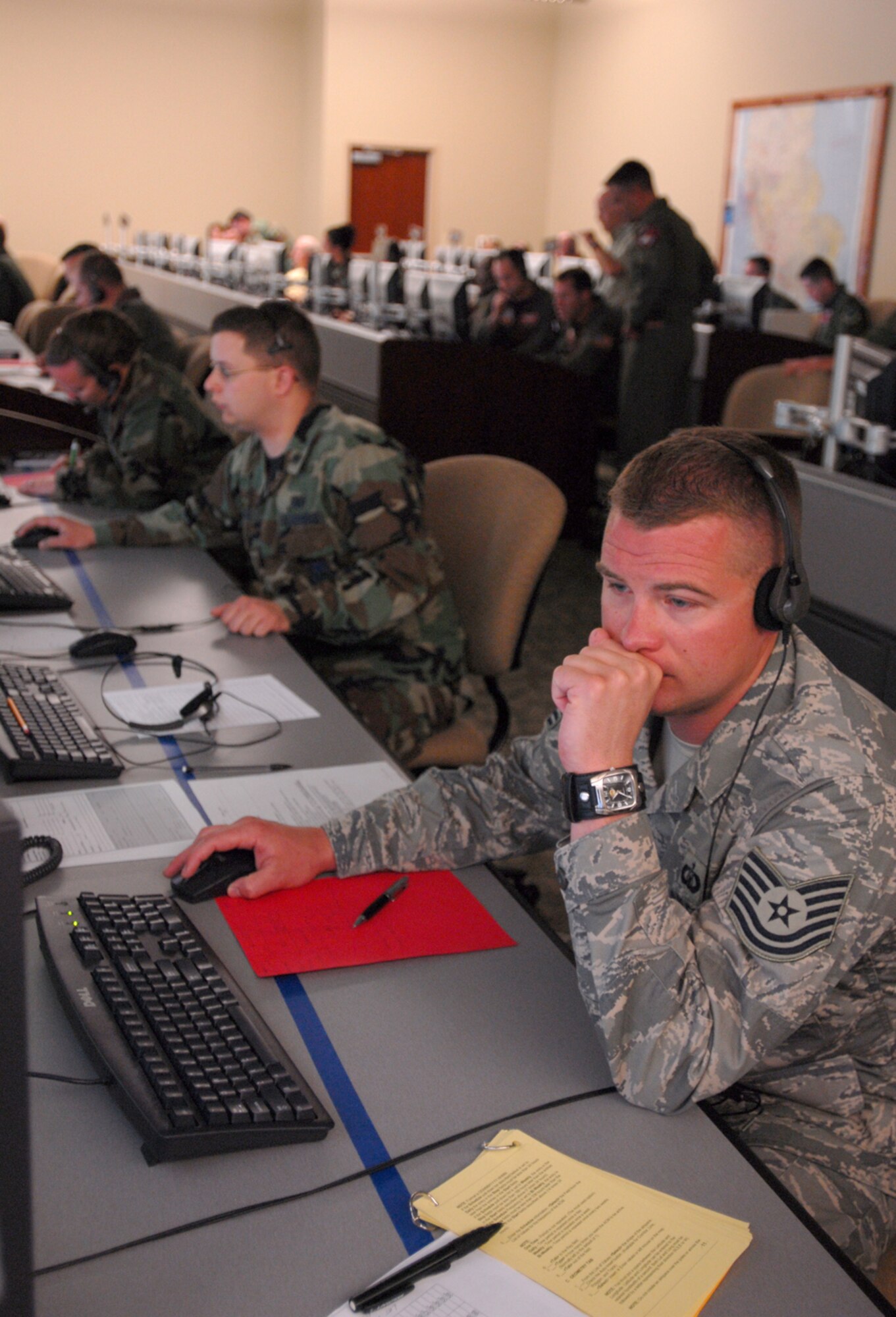 (Right to left) Tech. Sgt. Ryan Petterson, 1st Lt. Pan Hall and Maj. Jennifer Maceda, students at the 505th Training Squadron, manage air and space operations during an end of course exercise March 19 at Hurlburt Field. The exercise tests operational level command and control in an air operations center. (U.S. Air Force photo/Airman 1st Class Jason Epley)