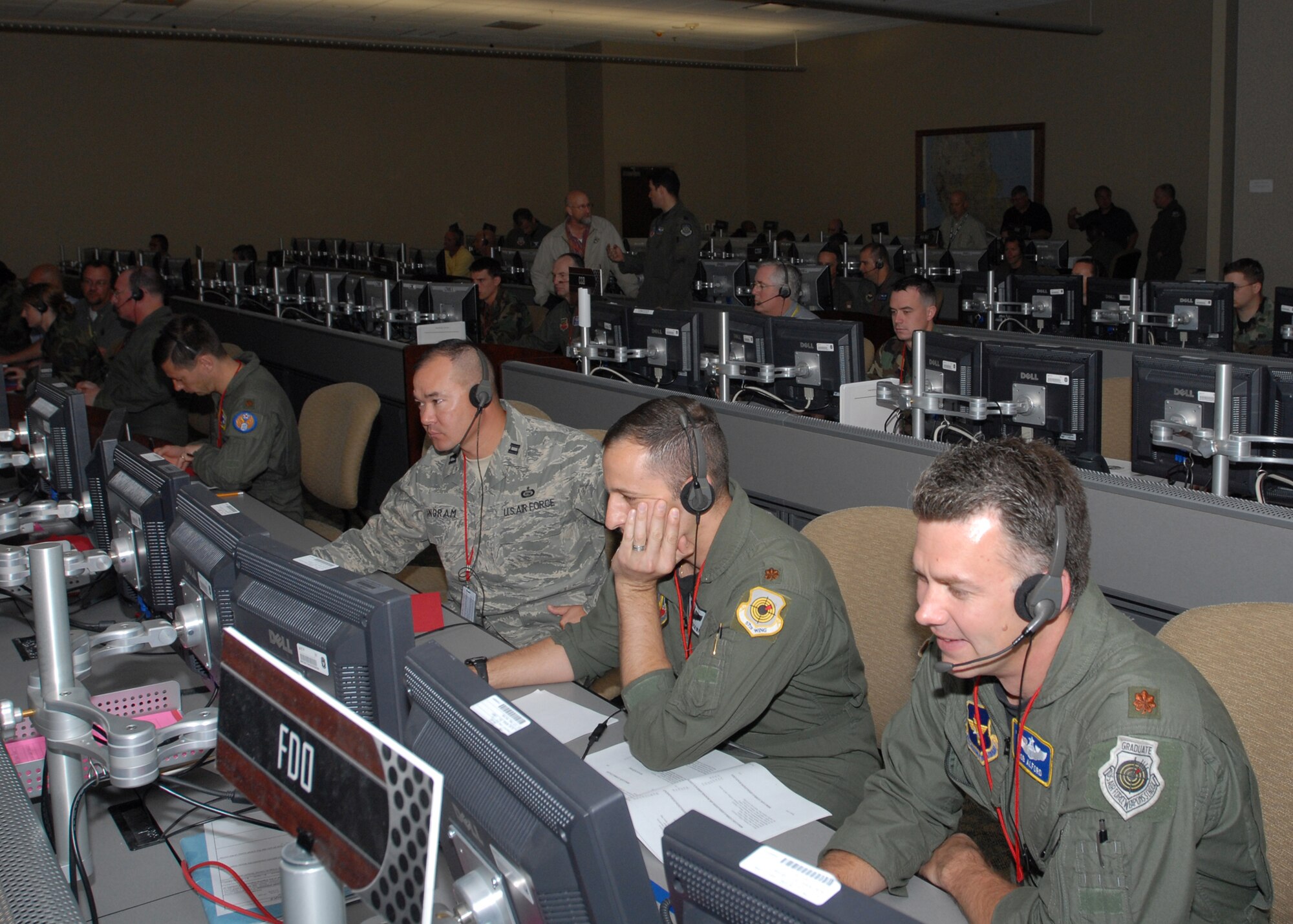 Maj. Rob Alford (right), Maj. Paul Rockway (middle), and Capt. Joe Ingram (left), students at the 505th Training Squadron, manage and monitor fighter aircraft during an end of course exercise March 19 at Hurlburt Field. The exercise tests operational level command and control in an air operations center. (U.S. Air Force photo/Airman 1st Class Jason Epley)
