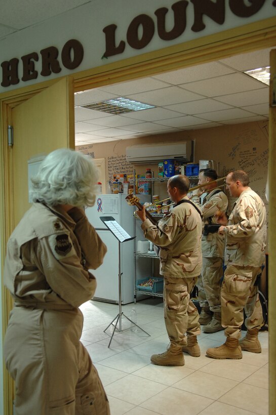 BALAD AIR BASE, Iraq -- Maj. Melinda Screws, 332nd Expeditionary Aeromedical Squadron flight nurse, listens in as three members of Hot Brass play at the Contingency Aeromedical Staging Facility hero lounge for wounded servicemembers here, April 8. Hot Brass is a part of the U.S. Air Forces Central Band deployed from Scott Air Force Base, Ill. Major Screws is deployed from Patrick Air Force Base, Fla. (U.S. Air Force photo/ Senior Airman Julianne Showalter)