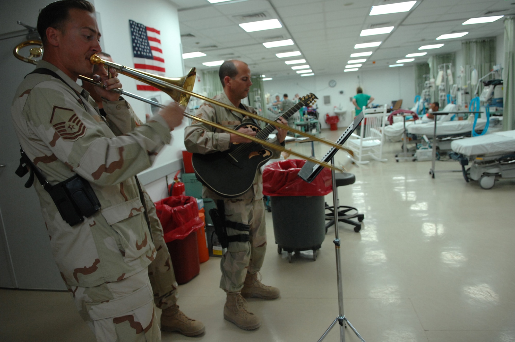 BALAD AIR BASE, Iraq -- Three members of Hot Brass, U.S. Air Forces Central Band, play a tune for staff and patients in the intensive care unit at the Air Force Theater Hospital here, April 8. Hot Brass consists of nine musicians, in order to remain mobile in the hospital they performed with three people. Members of Hot Brass are deployed from Scott Air Force Base, Ill. (U.S. Air Force photo/ Senior Airman Julianne Showalter)