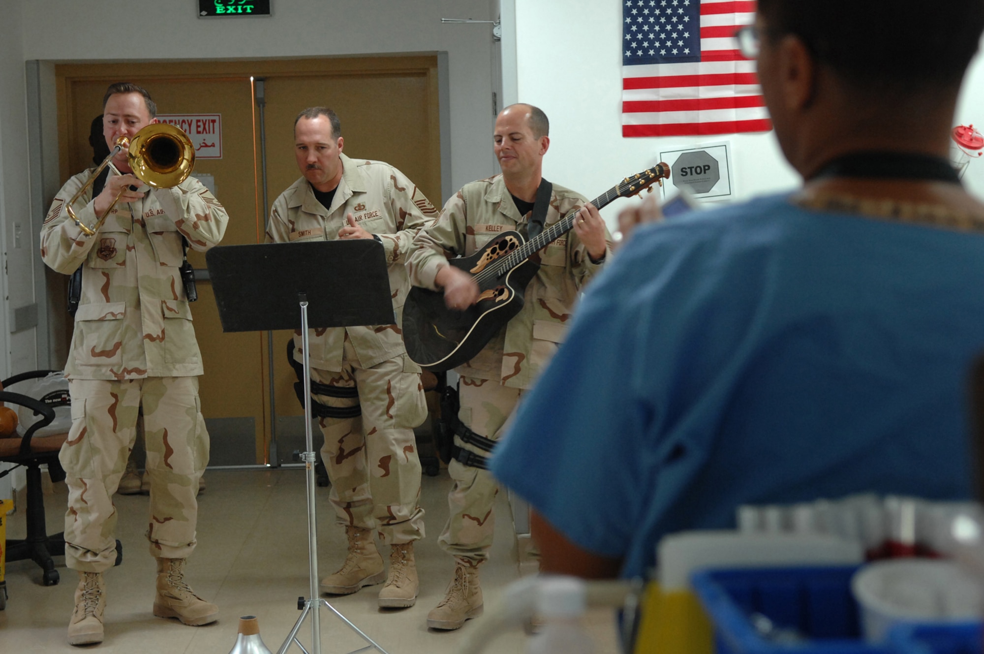 BALAD AIR BASE, Iraq -- Three members of Hot Brass, U.S. Air Forces Central Band, play a tune for staff and patients in the intensive care unit at the Air Force Theater Hospital here, April 8. Working in the intensive care unit can sometimes be taxing on the morale of the staff, but when the musicians rolled in and played a few sets, the room was all smiles. Members of Hot Brass are deployed from Scott Air Force Base, Ill. (U.S. Air Force photo/ Senior Airman Julianne Showalter)