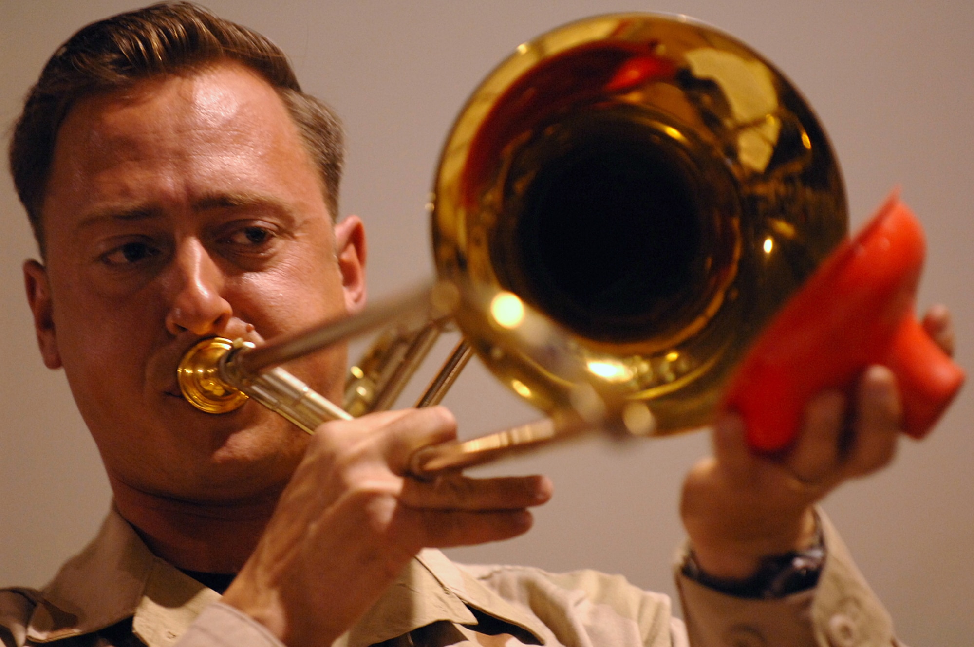 BALAD AIR BASE, Iraq -- Master Sgt. Richard Thorp, U.S. Air Forces Central Band Hot Brass, plays trombone during a performance for servicemembers here, April 8. The nine-member band came to Balad to bring smiles and relaxation for all personnel; they played a mixture of old and new songs to include Brown Eyed Girl by Van Morrison and Home by Daughtry.  The band is deployed from Scott Air Force Base, Ill. (U.S. Air Force photo/ Senior Airman Julianne Showalter)