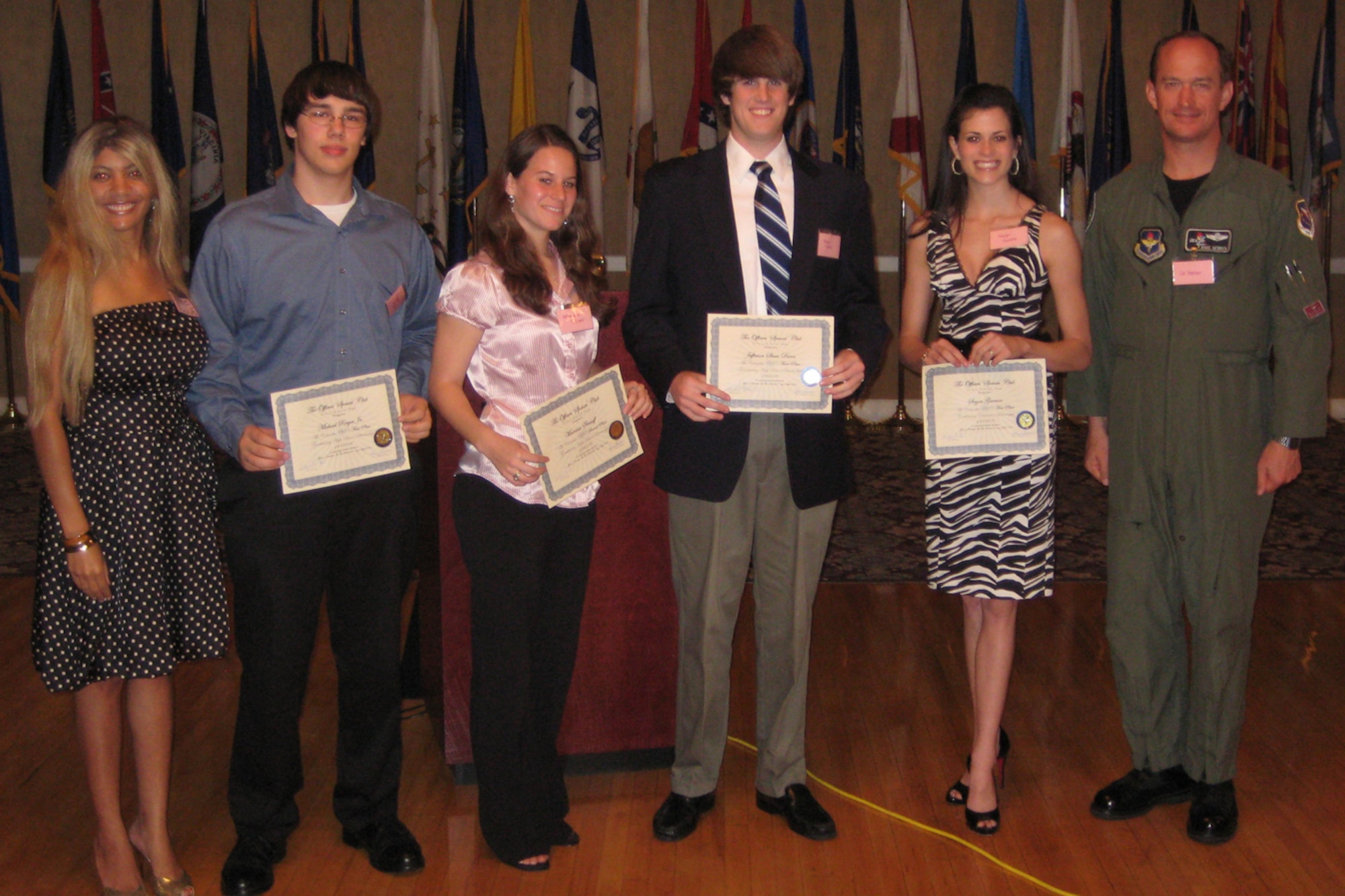 The Officers Spouses' Club handed out scholarships to three area college students and one high school senior Tuesday night at their April Social. Pictured are: Sarah Dixon, President of OSC; Michael Rieger, Jr., first place; Marrissa Senneff, second place, Shaw Dunn, third place; and Sagen Gunnoe, first place; and Co. Dave Gerber, 14th Flying Training Wing commander. (U.S. Air Force photo by Airman Josh Harbin)
