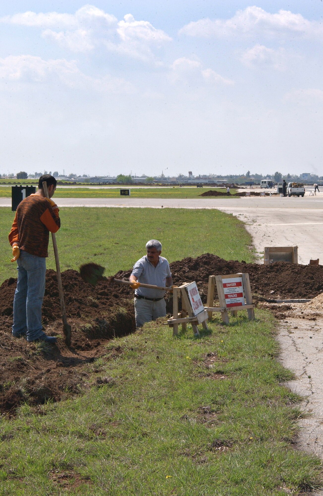 Contractors dig a ditch beside the Incirlik runway April 2. A fuel line will be laid in the ditch. repairs to the runway are sceduled to be completed April 22. (U.S. Air Force photo by Airman 1st Class Benjamin Wilson)     