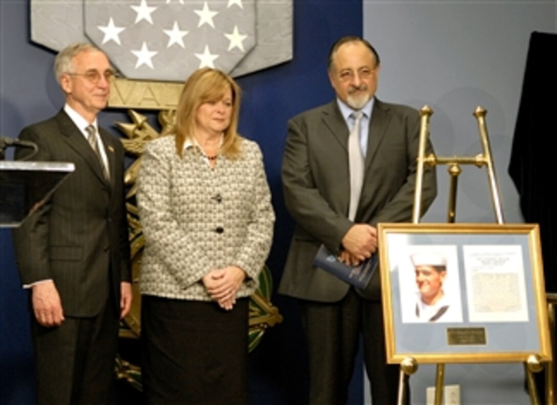 Deputy Defense Secretary Gordon England, left, stands next to Sally and George Monsoor after unveiling the Hall of Heroes induction citation in honor of their late son U.S. Navy Petty Officer 2nd Class Michael A. Monsoor, a Navy SEAL, in the Pentagon April 9, 2008. 