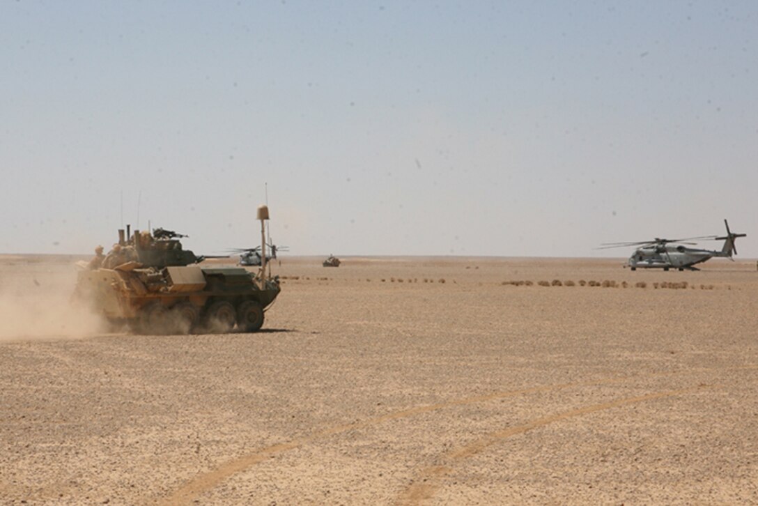 A Light Armored Vehicle 25 A2 from Charlie Company, 2nd Light Armored Reconnaissance Battalion, Regimental Combat Team 5, drives off to be refueled during a re-supply mission in western Anbar province, Iraq, April 9. A new site for LAV-25's weapon system was used by Charlie Company during Mojave Viper's at Marine Air Ground Combat Center, Twentynine Palms, Calif., ensuring gunners would be efficient with the sites for deployment.