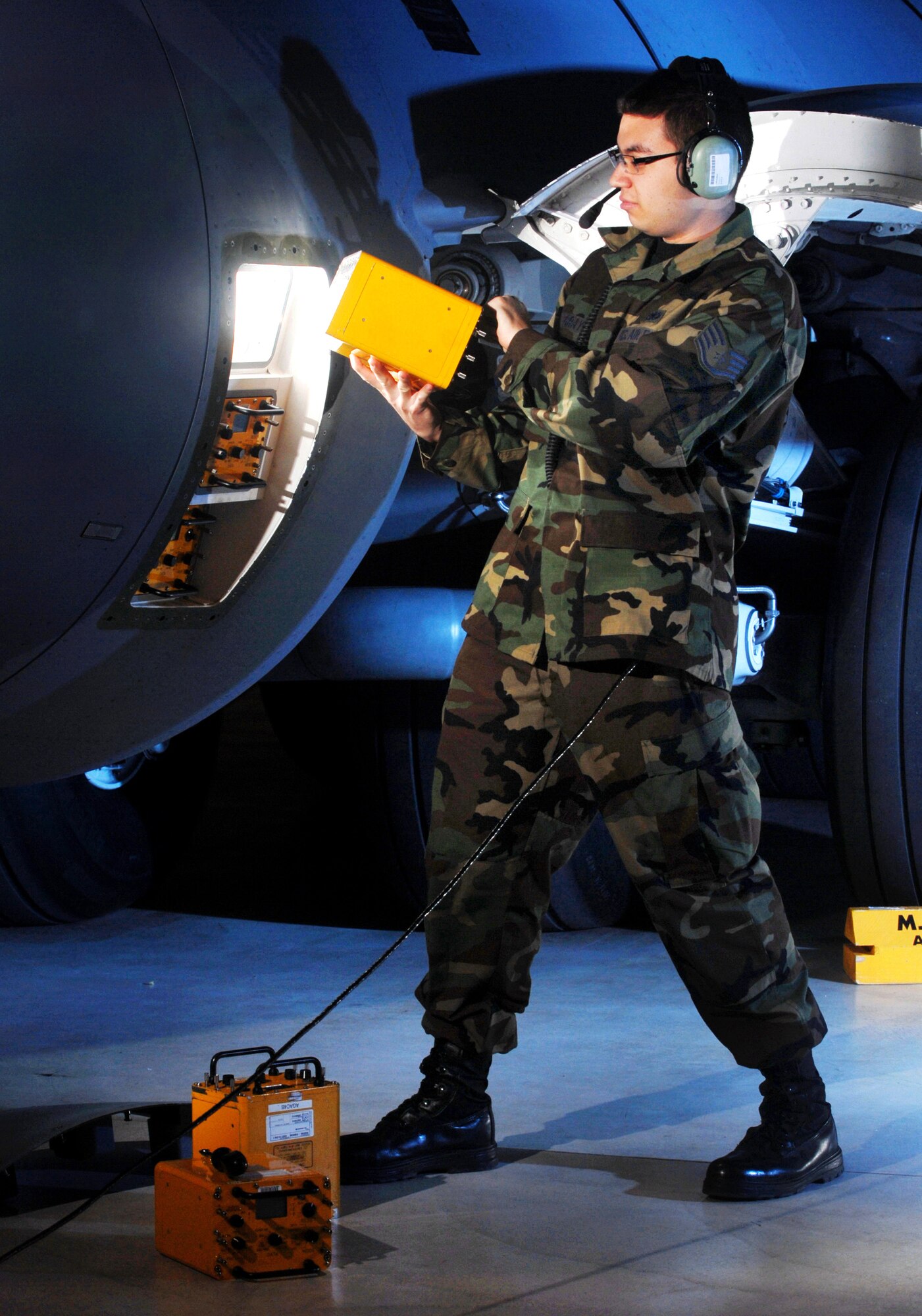 Staff Sgt. John Gray, an electronics warfare technician from the 452nd Maintenance Squadron, March Air Reserve Base, installs a test set on the flare bucket of a C-17 Globemaster III cargo aircraft. (Photo by Val Gempis)