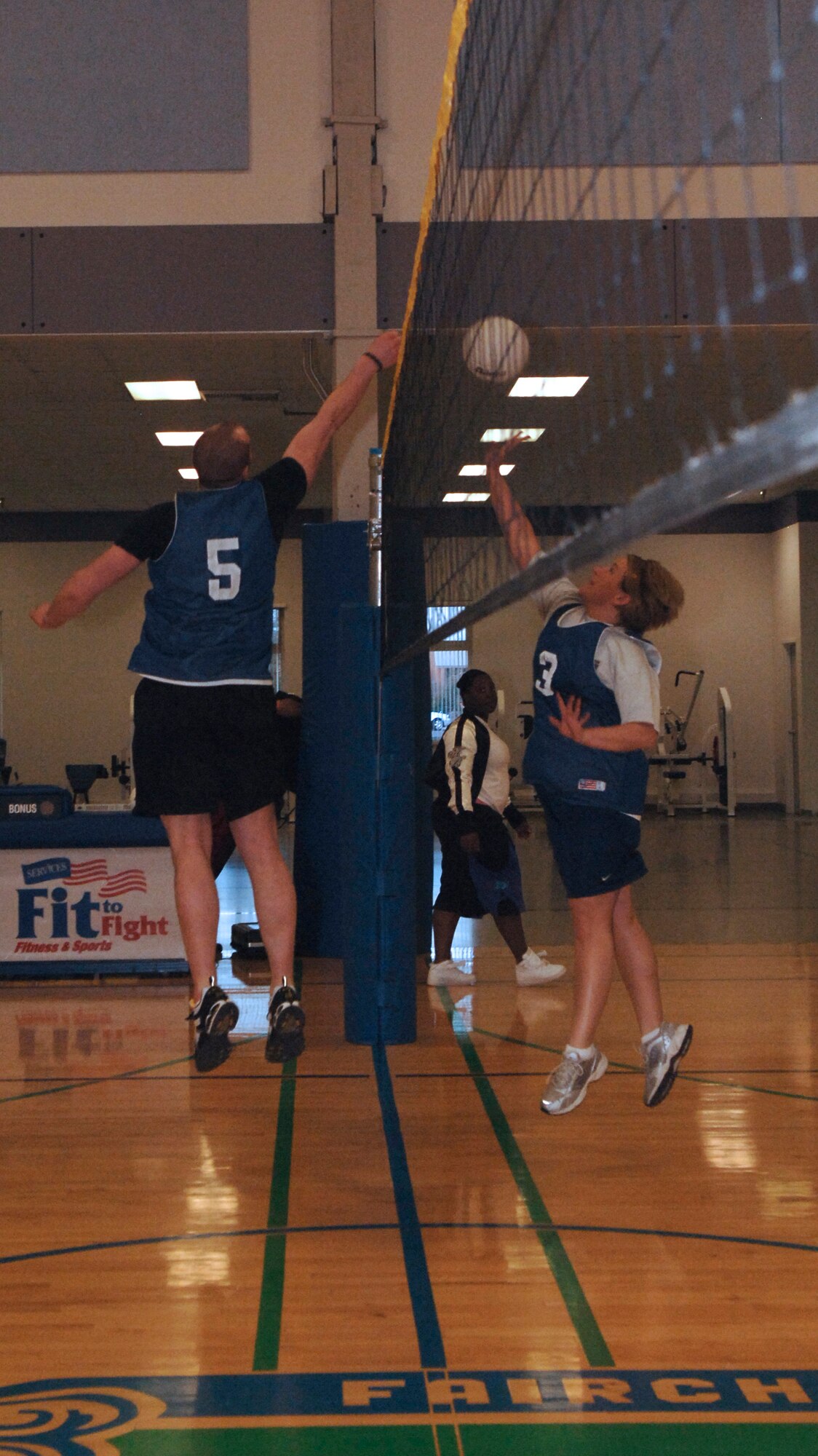FAIRCHILD AIR FORCE BASE, Wash. – Senior Airman Christian Fountain, 22nd Training Squadron survival instructor, taps the ball across the net to opposing teammember Tara Funderberg, 336th Training Group secretary to the commander, during a scrimmage volleyball game at the Fitness Center here April 9. (U.S. Air Force photo / Airman 1st Class Darlene West) 
