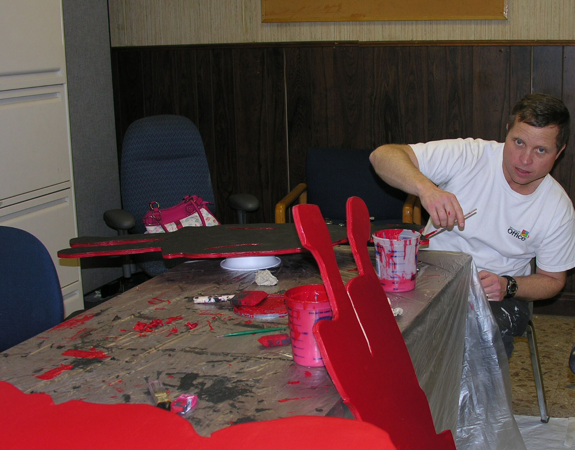 Senior Master Sgt. Walter Bonner, 22nd Mission Support Group, paints several McConnell Silent Witness exhibits March 15, in Hanger 1129.  According to Child Help, An estimated 906,000 children are victims of abuse & neglect every year. McConnell Silent Witness exhibits are meant to bring awareness to members about how child abuse and domestic violence may carry vital consequences. (courtesy photo)