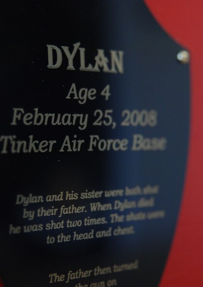 The story of slain abuse victims cover the front of McConnell’s Silent Witness exhibits on display throughout the base to recognize abuse awareness month in April. One particular sign shares the story of a child who was killed at Tinker Air Force Base, Okla. (photo by Airman 1st Class Jessica Lockoski)