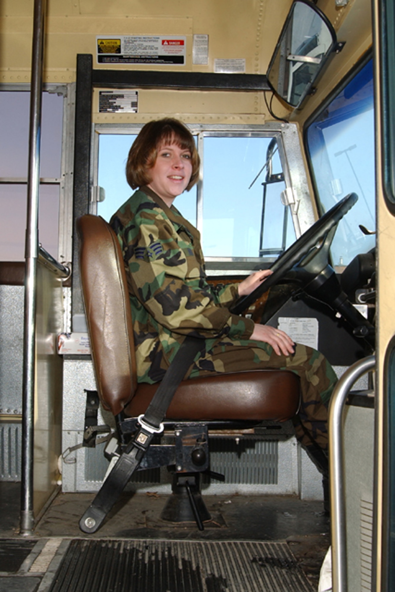 119th Wing member of the transportation and vehicle maintenance squadron drives a bus on base.