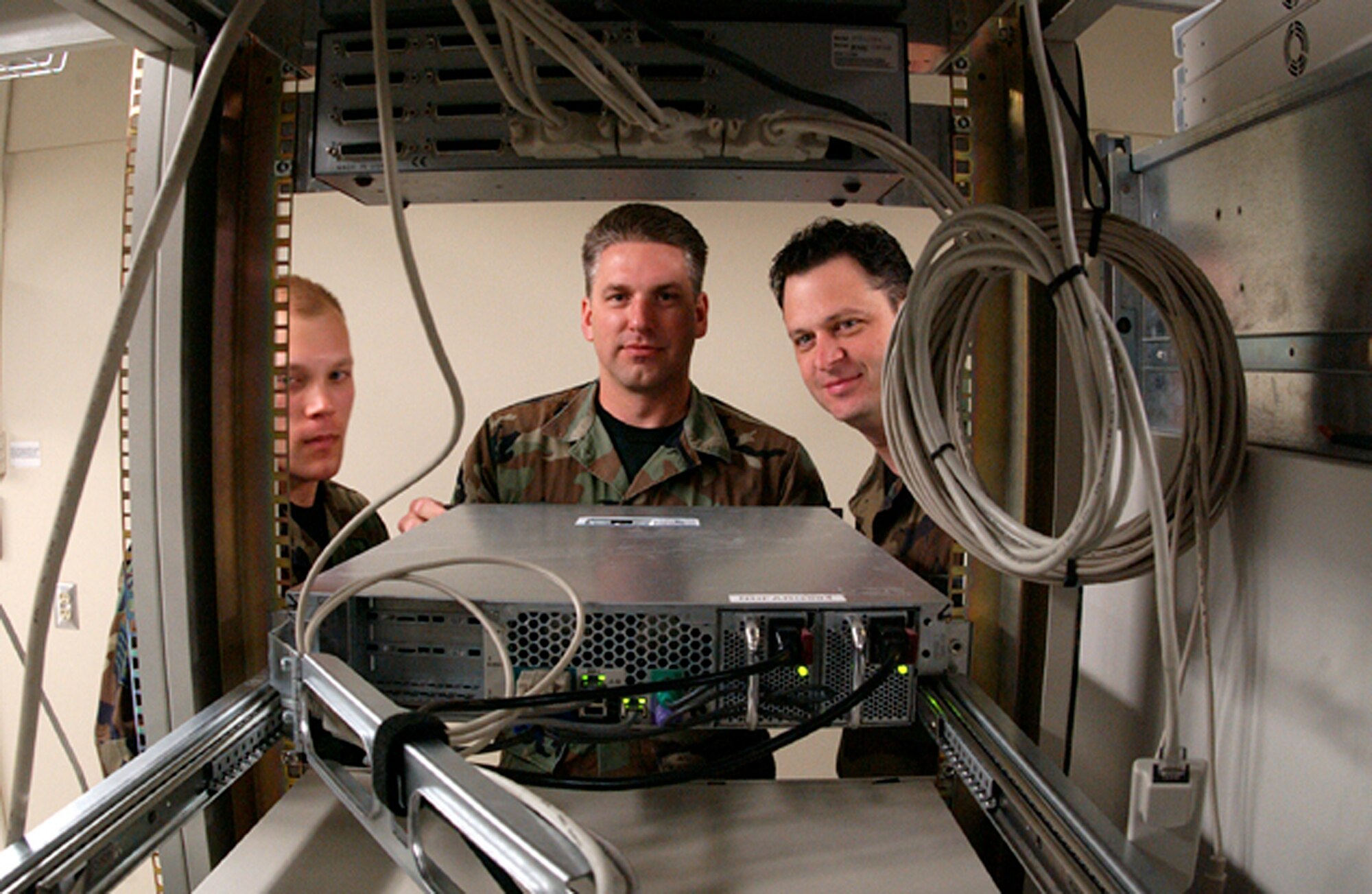 119th Wing members from the Communications Flight inspect equipment.
