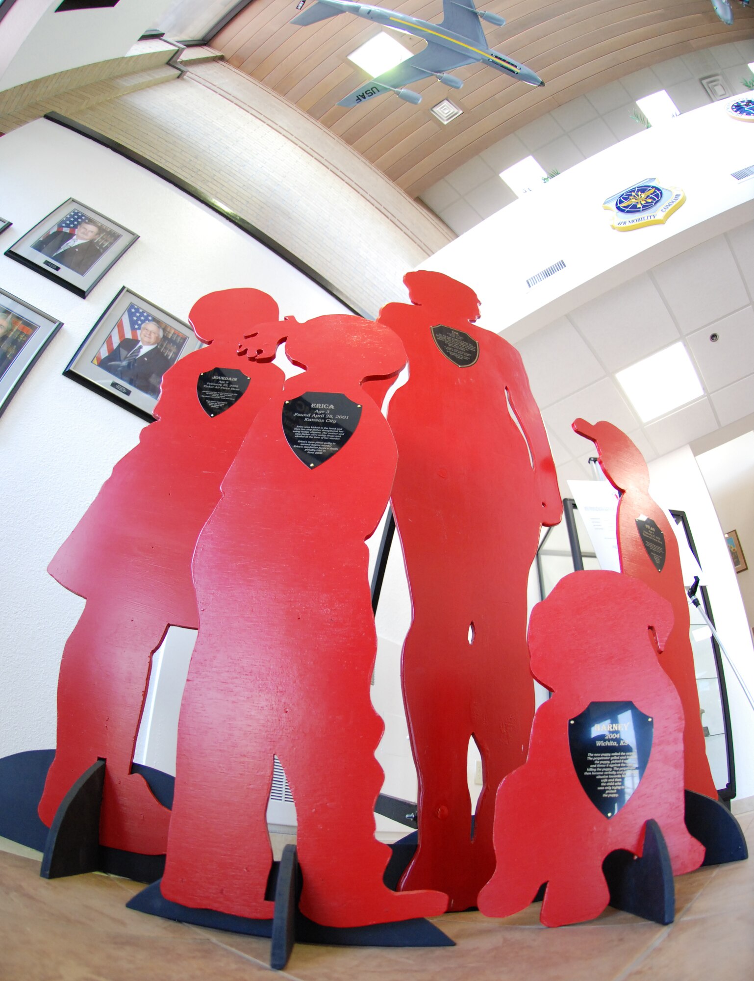 Silent Witness statuettes huddle in the main entrance of the wing headquarters building April 7, in honor of Child Abuse Prevention Month. The Silent Witness Initiative goal is to promote domestic and child violence reduction efforts in communities across the nation and in other countries. (photo by Airman 1st Class Jessica Lockoski)