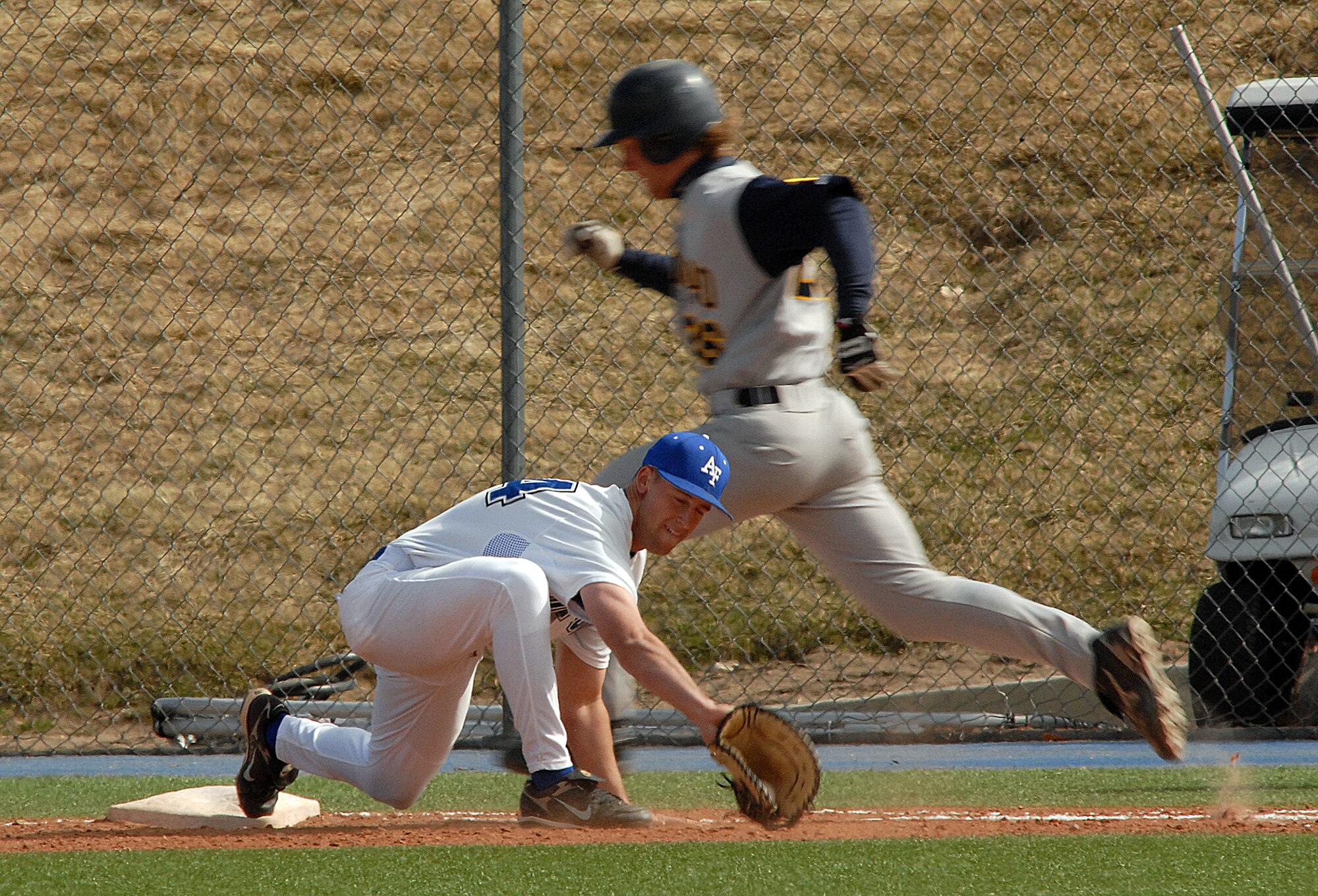 Sophomore first baseman Addison Gentry stretchs to make the put out at first as the Falcons rallied to a 10th inning 9-8 win against Colorado Christian in non conference baseball action at the Academy's Falcon Field. Air Force tallied 12 hits and did not commit an error in the field on the day. The Falcons improve to 11-19 on the season. (U.S. Air Force photo/Dave Ahlscwhede)
