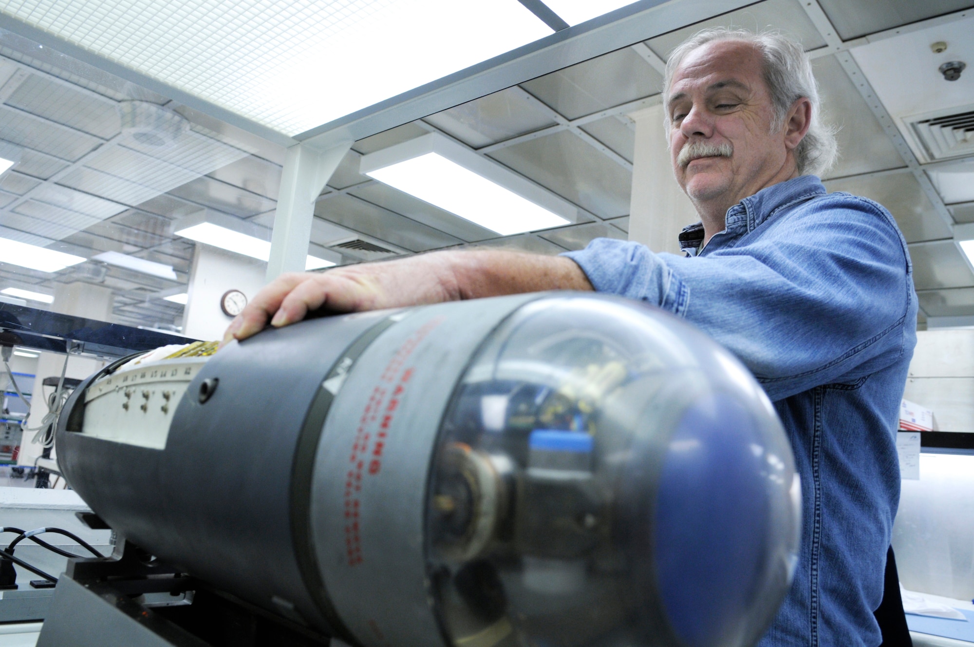 Earl Zonn troubleshoots and replaces damaged parts on the Pave Penny. U. S. Air Force photo by Sue Sapp