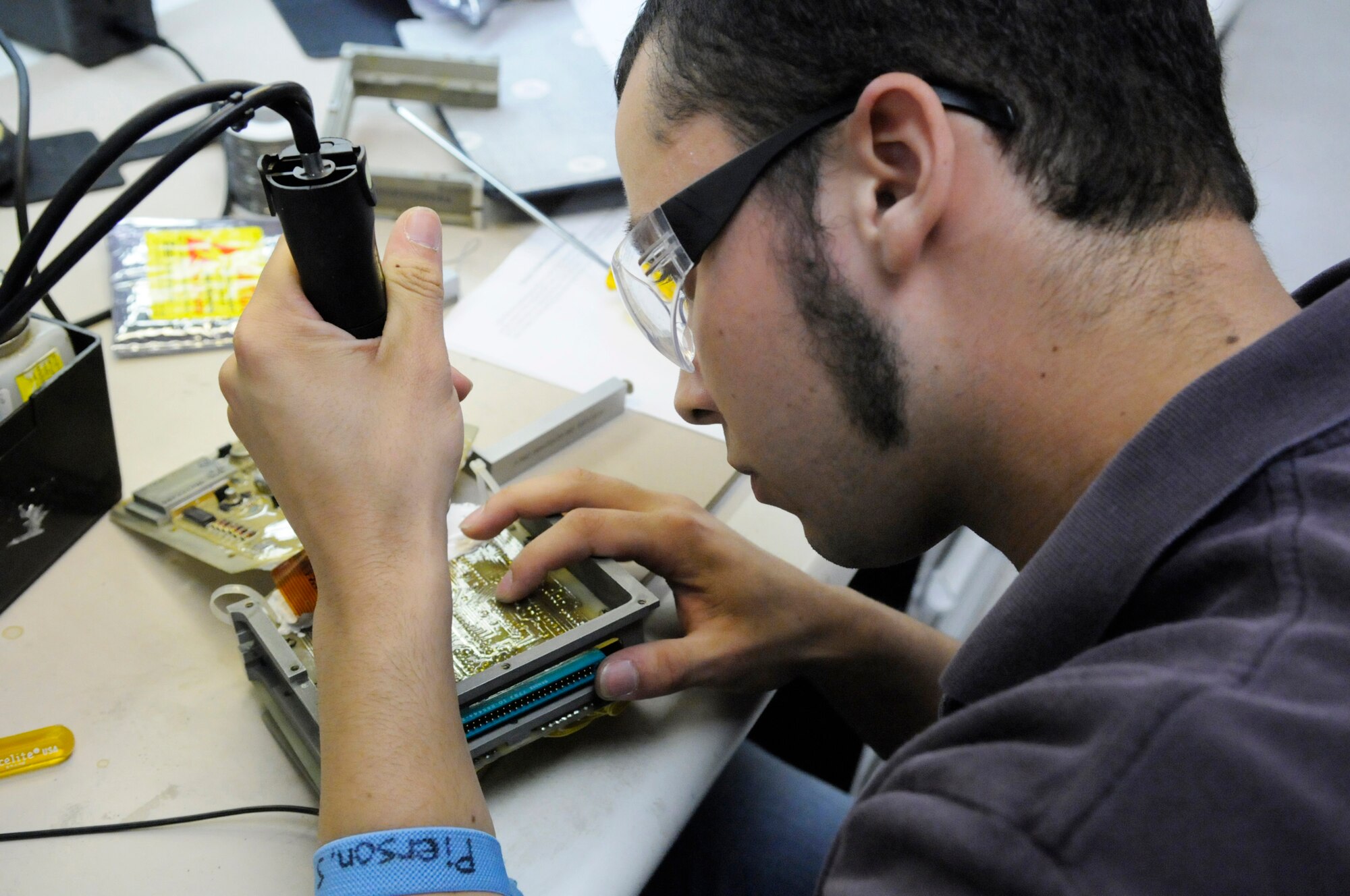 Steven Pierson, electronics technician, repairs solder joints on an A-9 decoder card for the Pave Penny pod. U. S. Air Force photo by Sue Sapp