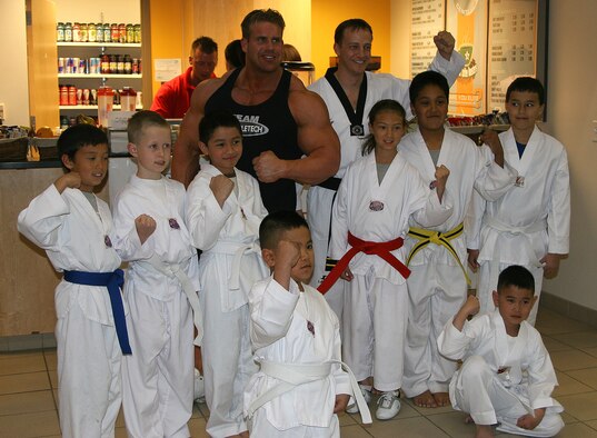 Jay Cutler, Mr. Olympia 2007, smiles with a group of Tae Kwon Doe students at the Fitness and Wellness center at Hill Air Force Base March 28. Mr. Cutler visited Hill AFB to meet with fans, sign autographs and pose for photos.