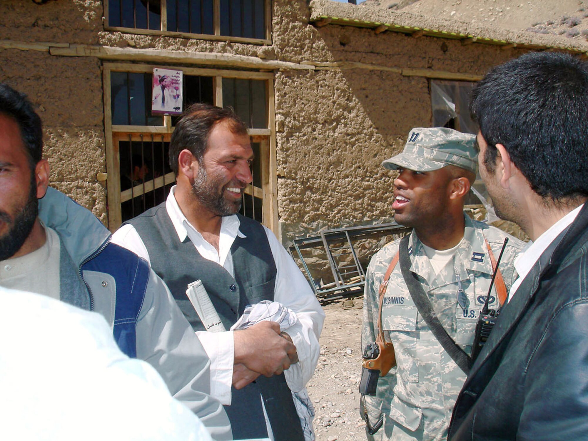 Capt. Kenneth McGinnis discusses foundation specifications for a schoolbook repository with the project's main contractor Haji Fada at the Khenj District Center April 1 in Afghanistan. The $220,000 building is expected to be complete in January 2009 and furthers one of the key tenets of the Panjshir Provincial Reconstruction Team mission -- governance. The captain is a PRT engineer. (U.S. Air Force photo/Capt. Jillian Torango) 