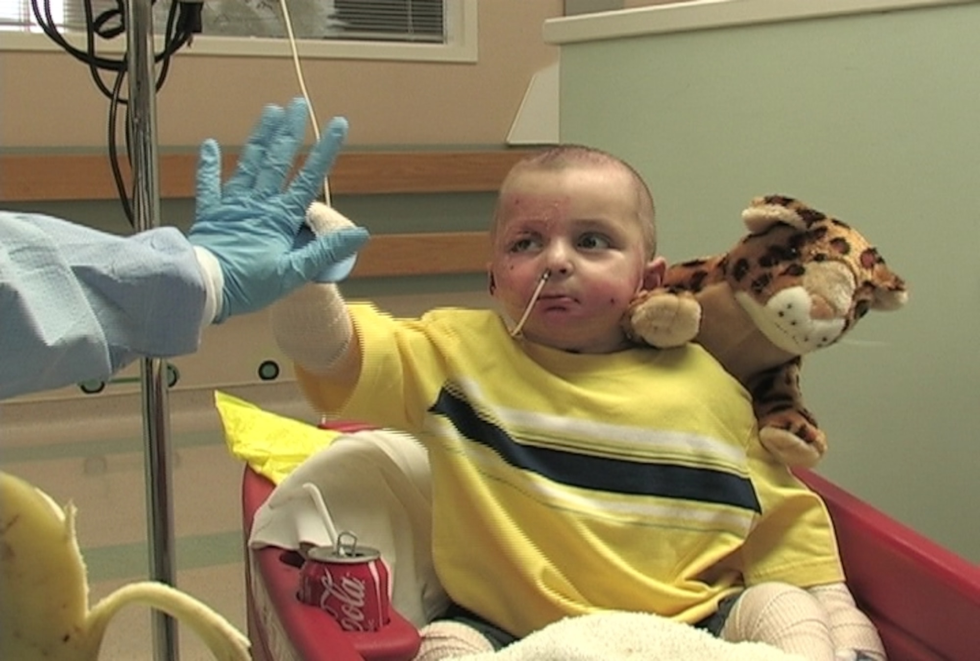 Little Al Amreeki gives a high five to his interpreter, Nadia Shaya, at Shriners Hospital in   Cincinnati. (Air Force photo by Ken LaRock)