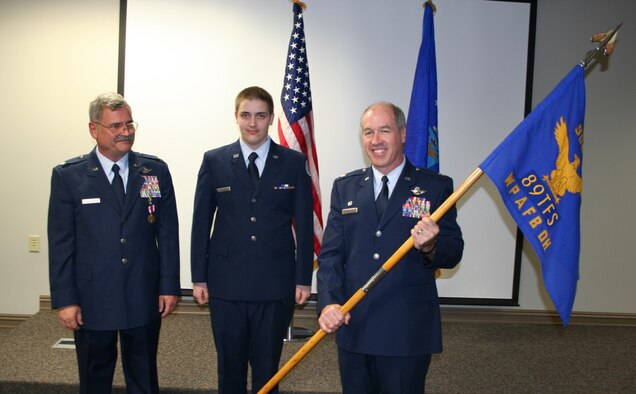 WRIGHT-PATTERSON AFB, Ohio - To remember the proud heritage of the 906th Fighter Group, Col. Stephen M. Bastian with his son, a Junior ROTC member, present
Lt. Col. Baldwin, 89th Airlift Squadron commander with the guidon he saved from the deactivated 906th Fighter Group. (U.S. Air Force photo/Senior Airman Ken LaRock)