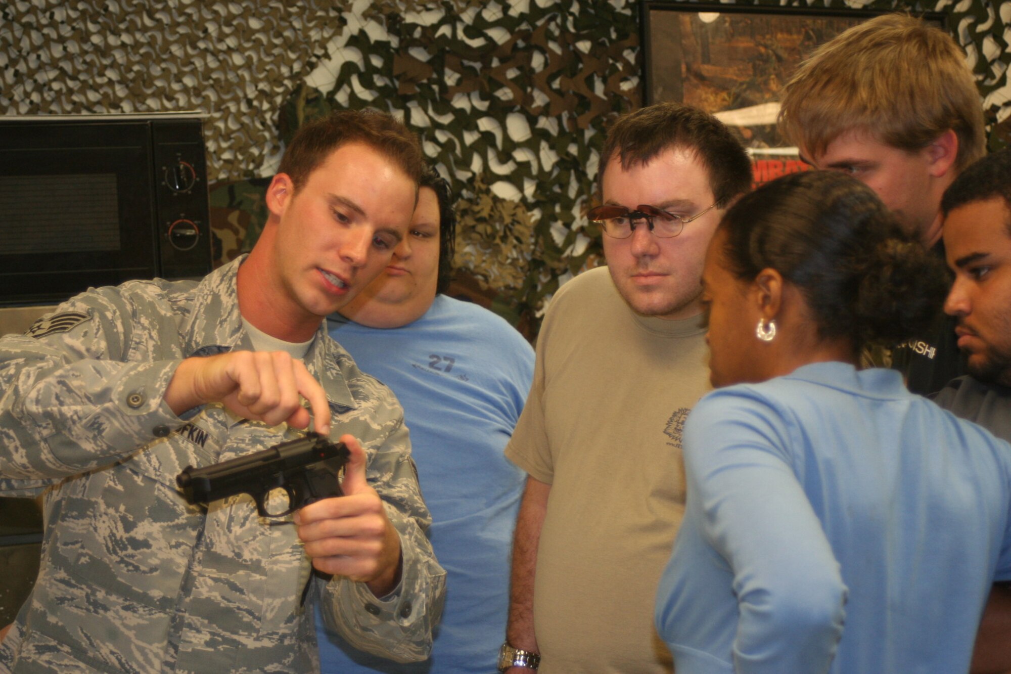 PATRICK AIR FORCE BASE, Fla. - Staff Sgt. Terry Bufkin of the 45th Security Forces Squadron shows the attributes of a pistol to a group of students from Brevard Community College. (U.S. Air Force photo by Airman 1st Class David Dobrydney)