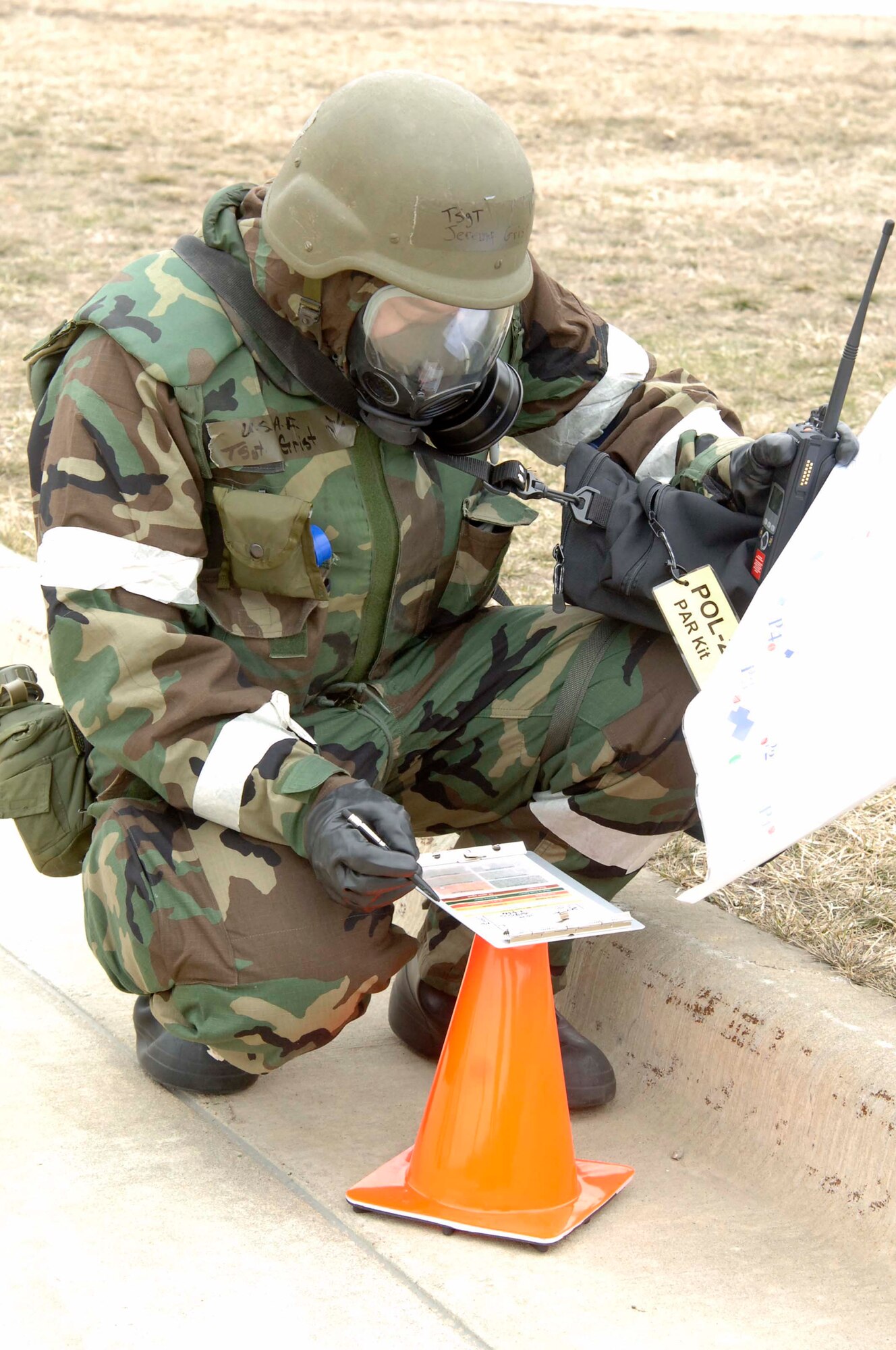 VOLK FIELD AIR NATIONAL GUARD BASE, Wis. -- Tech. Sgt. Jeremy Grist, a fuels specialist from McConnell Air Force Base, Kan., checks a for chemical contamination after a simulated attack on Apr. 3 at an exercise in Volk Field.  The fuels flight is responsible for receiving, purchasing, issuing and testing of all fuels on the base. (Photo by Tech. Sgt. Chyrece Campbell)