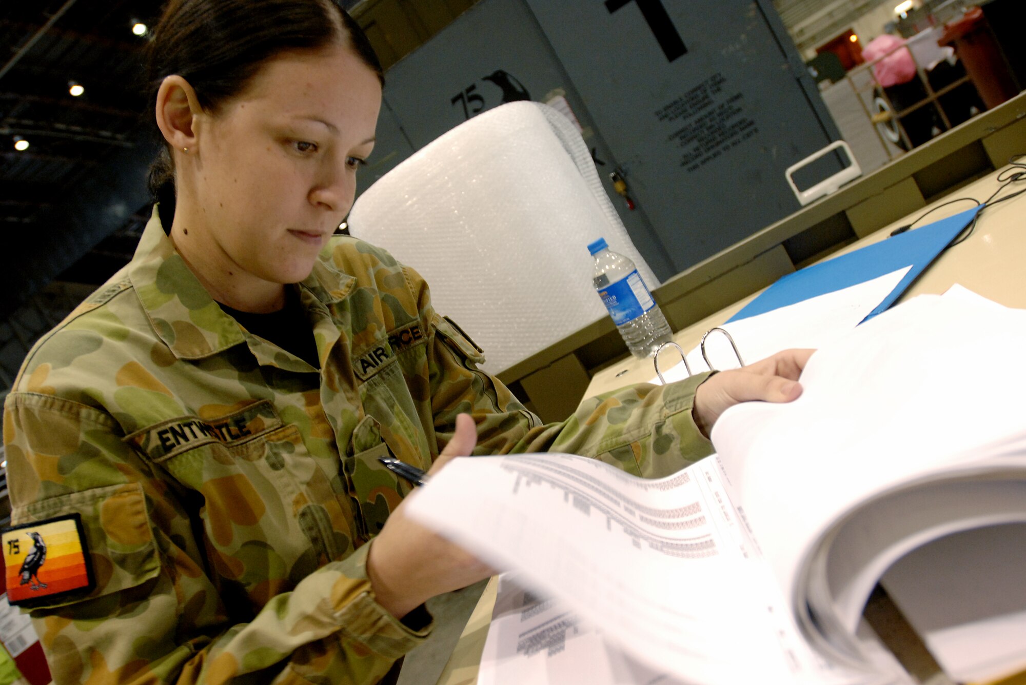 Royal Australian air force's Number 75th Squadron Leading Aircraftwoman Trish Entwistle searches through an aircraft parts log to determine what parts are needed for pre-flight maintenance on the Australian F/A-18 Hornet jets on April 7, 2008, at Eielson Air Force Base, Alaska. The Australian air force 75th Squadron is a participant of the RED FLAG-Alaska 08-2 exercise.   RED FLAG-Alaska is a series of Pacific Air Forces field training exercises for U.S. Forces and allies that provide joint offensive counter-air, indirection, close air support, and large force employment training in a simulated combat environment.

(U.S Air Force Photo by Technical Sgt. Eric T. Sheler)
