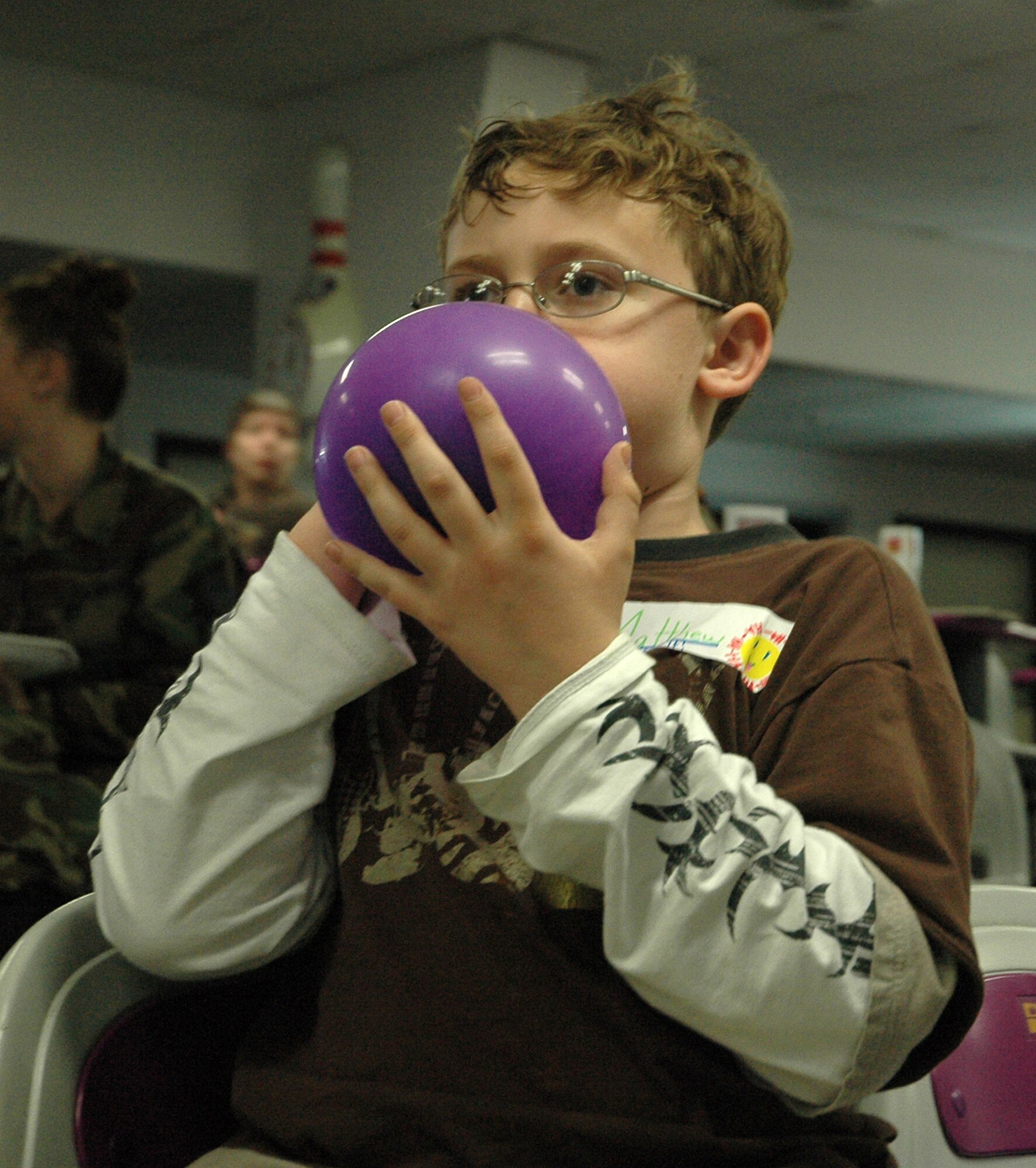 Matthew Anderson, son of Capt. Cathy Anderson, 512th Military Personnel Flight commander, prepares more ammunition for a balloon fight as part of the "Month of the Military Child" celebration here April 5. Children participated in multiple events held throughout the base including arts and crafts, a pizza party and a movie presentation.