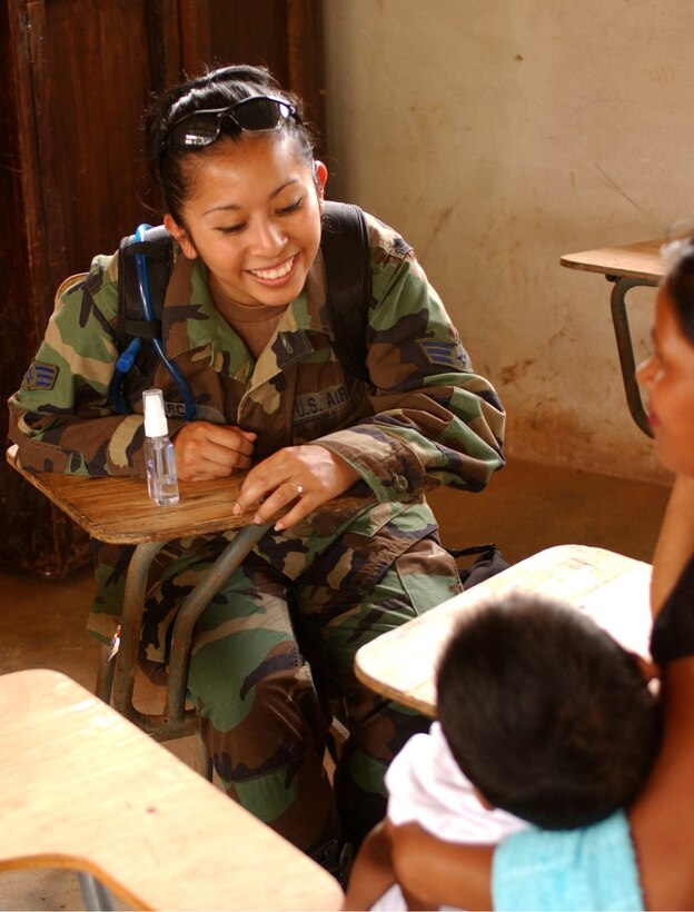 LAGUNA DEL RINCON, Honduras - U.S. Air Force Senior Airman Rosalba Garcia from the 155th Medical Group, Nebraska Air National Guard, chats with a Honduran family to ascertain the medical treatment it might require during a daylong visit to this rural town. U.S. military medical personnel are in Honduras for the joint training exercise Beyond the Horizon. The event provides medical attention, as well as infrastructure renovation, to rural areas in this Central American country. (Photo by Sgt. Claude W. Flowers, 304th Public Affairs Detachment.)