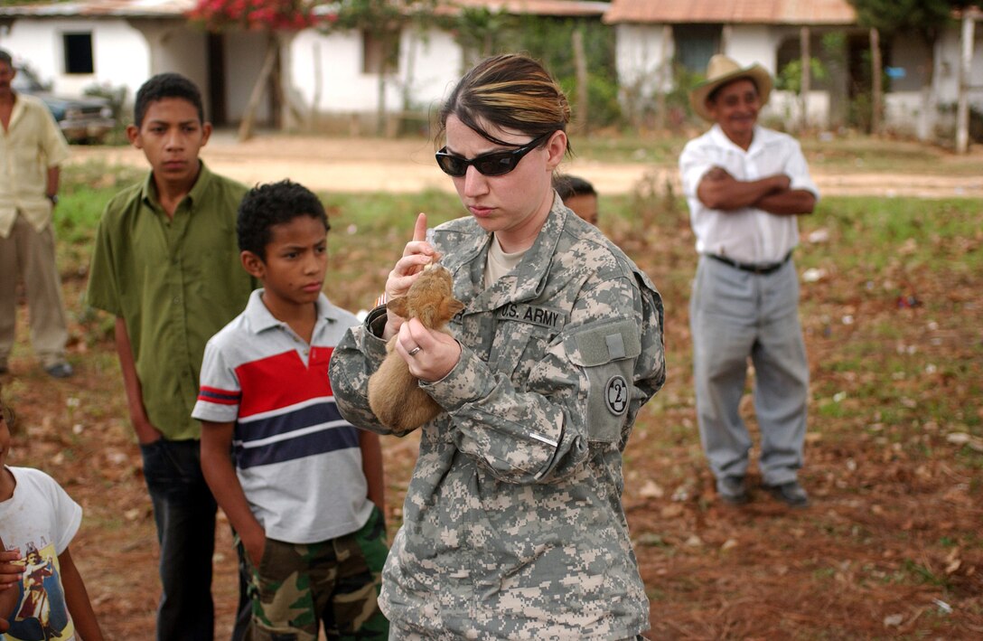 LAGUNA DEL RINCON, Honduras - Army Reserve Sgt. Mitzi L. Porter of the 993rd Medical Detachment (Veterinary Services) of Aurora, Colorado, administers de-worming medication to a puppy. Veterinarians, like Sergeant Porter, provide basic medical and dental care to dogs, cats and livestock during daylong visits to this and other remote Honduran villages. U.S. military medical personnel are in Honduras for the joint training exercise Beyond the Horizon. The event provides medical attention, as well as infrastructure renovation, to rural areas in this Central American country. (Photo by Sgt. Claude W. Flowers, 304th Public Affairs Detachment.)