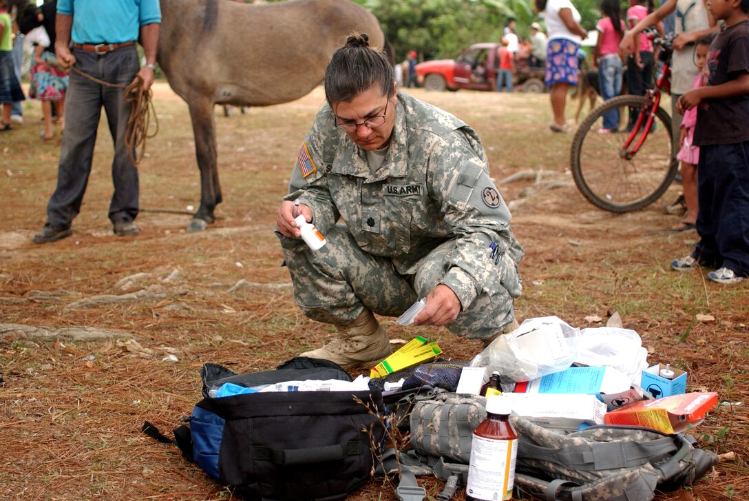 LAGUNA DEL RINCON, Honduras - Lt. Col. Shannon L. Sutherland selects the proper medication to administer to a horse. Veterinarians, like Colonel Sutherland, provide basic medical and dental care to dogs, cats and livestock during daylong visits to this and other remote Honduran villages. U.S. military medical personnel are in Honduras for the joint training exercise Beyond the Horizon. The event provides medical attention, as well as infrastructure renovation, to rural areas in this Central American country. (Photo by Sgt. Claude W. Flowers, 304th Public Affairs Detachment.)