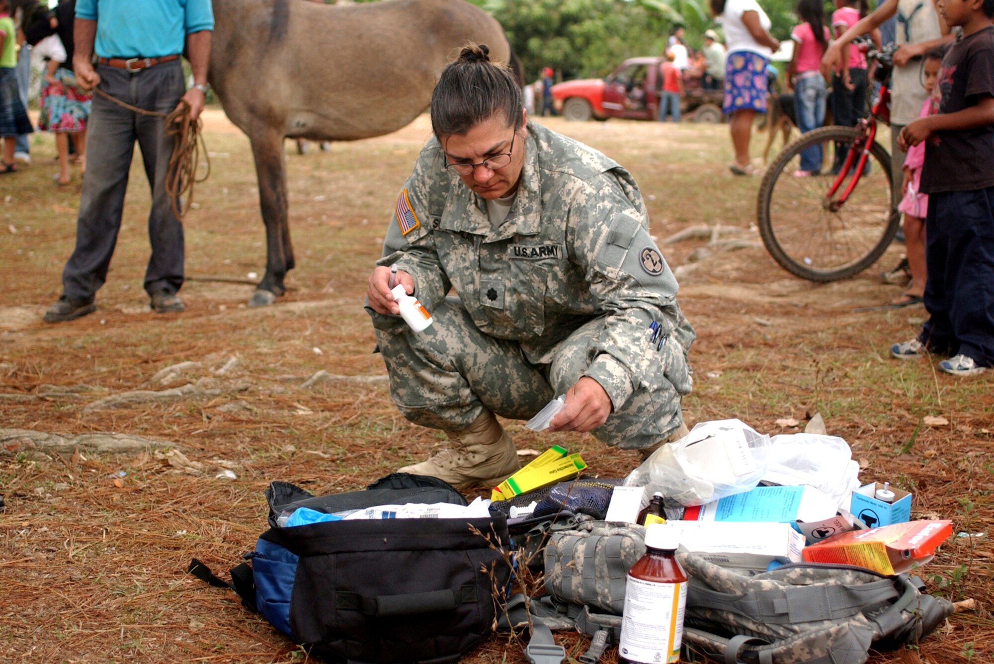 LAGUNA DEL RINCON, Honduras - Lt. Col. Shannon L. Sutherland selects the proper medication to administer to a horse. Veterinarians, like Colonel Sutherland, provide basic medical and dental care to dogs, cats and livestock during daylong visits to this and other remote Honduran villages. U.S. military medical personnel are in Honduras for the joint training exercise Beyond the Horizon. The event provides medical attention, as well as infrastructure renovation, to rural areas in this Central American country. (Photo by Sgt. Claude W. Flowers, 304th Public Affairs Detachment.)