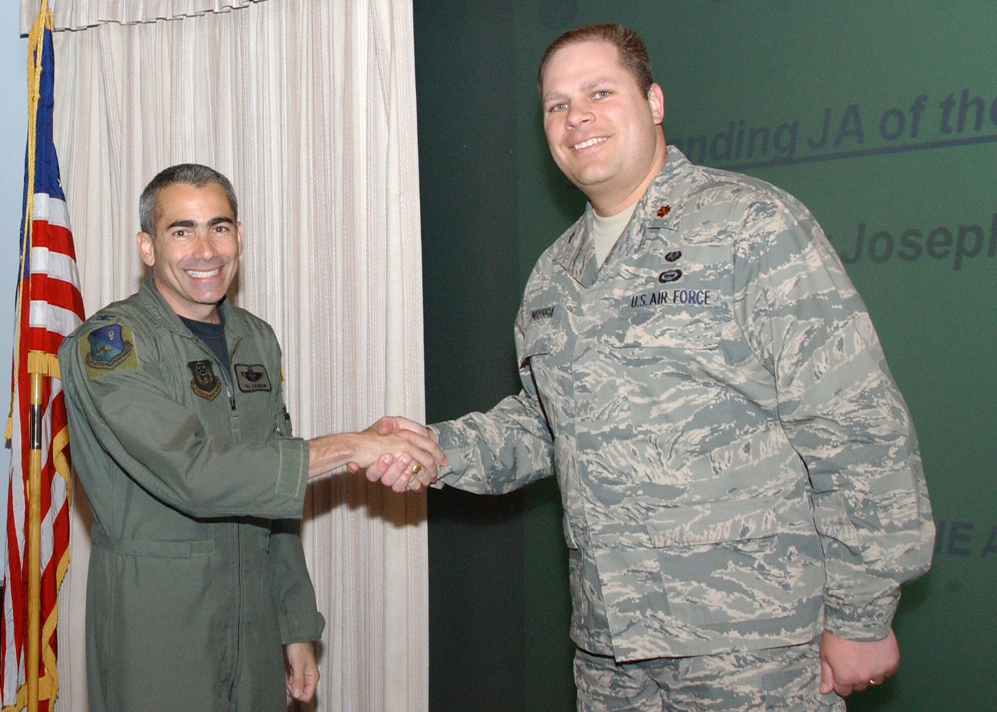 CANNON AIR FORCE BASE, N.M.-- Maj. Joseph Imburgia, 27th Special Operations Wing Legal Office, receives the Outstanding Judge Advocate award presented to him by Col. Valentino Bagnani III, 27th Special Operation Wing vice commander. Maj. Imburgia received the award at the weekly wing staff meeting on April 8. (U.S. Air Force photo by Airman Maynelinne De La Cruz)