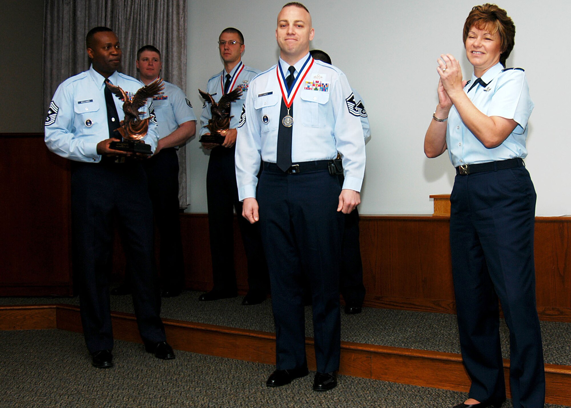 Air Force Recruiting Service members congratulate Master Sgt. Michael Lantz, 361st Recruiting Squadron, in a ceremony on Randolph Air Force Base, Texas, April 2 for winning the unit’s First Sergeant of the Year award. Air Force Recruiting Service Commander Brig. Gen. Suzanne Vautrinot, right, and Command Chief Master Sgt. Reginald Williams presented the award. The first sergeant assigned to McChord AFB, Wash., is one of the Air Education and Training Command 12 Outstanding Airmen of the Year and moves on to compete at Air Force-level. (U.S. Air Force photo/Staff Sgt. Jennifer Lindsey)