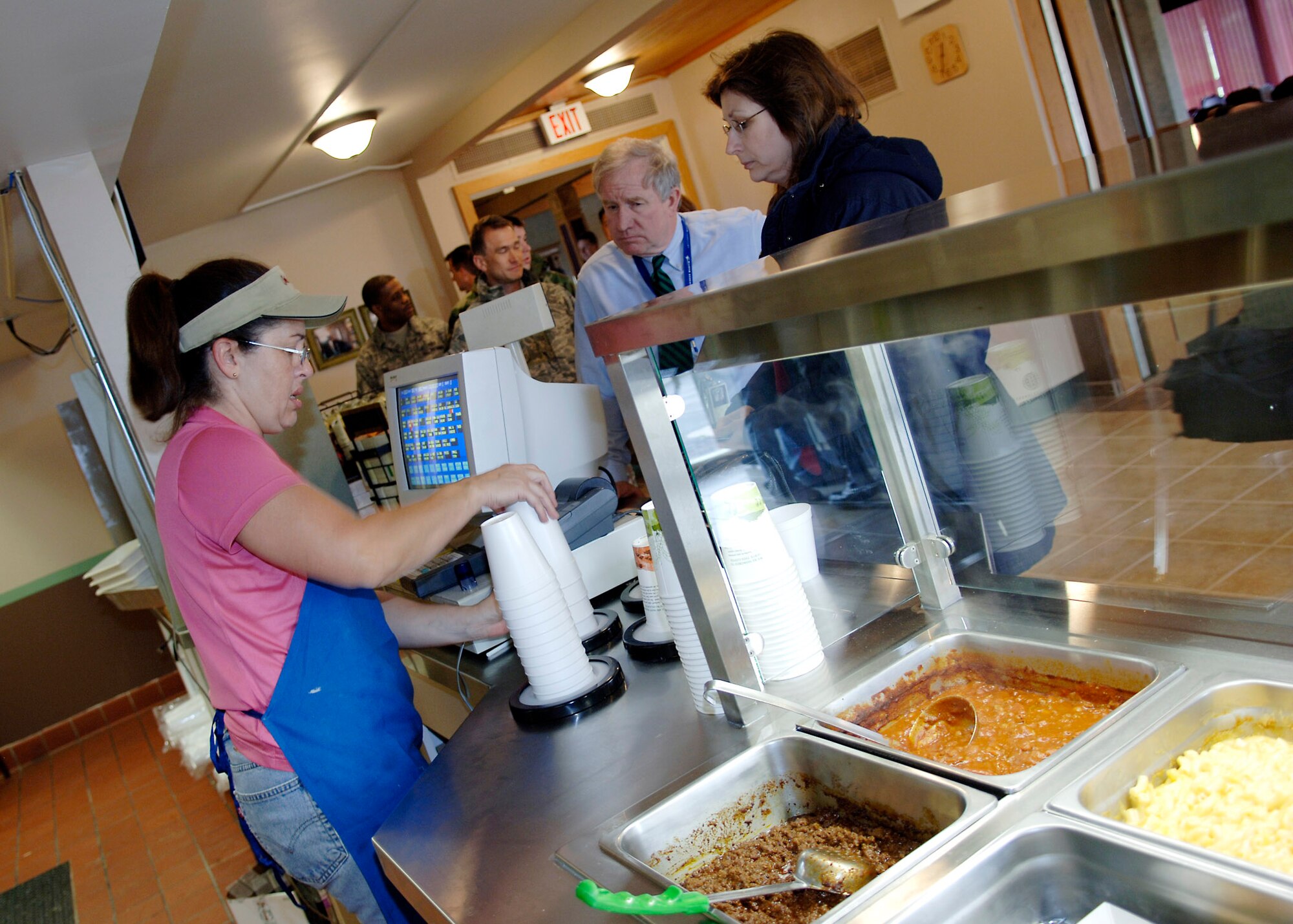 SCOTT AIR FORCE BASE, Ill. – Cardinal Creek Golf Course snack bar cahier Sue Paoli serves up beverages during the snack bar’s reopening March 28. The snack bar has been closed for two months undergoing a $166,000 renovation. The reopening was planned to coincide with a free golf day, but heavy rains the evening before waterlogged the golf course. (U.S. Air Force photo/Tech. Sgt. Tony Tolley)