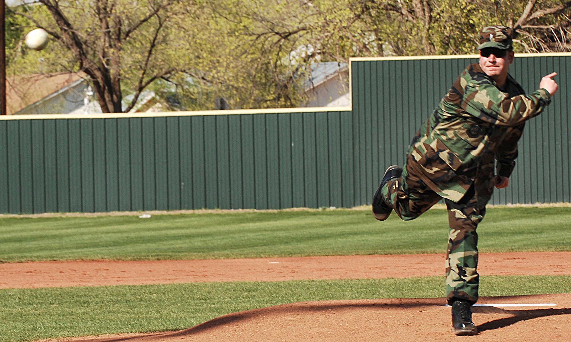CANNON AIR FORCE BASE N.M.--  1st Lt. Jason Wallace, 27th Special Operations Aircraft Maintenance Squadron, throws the first pitch during a Clovis High School baseball home game. The lieutenant was a member of the Air Force Academy baseball team during his college days.  (U.S. Air Force photo by Airman 1st Class Liliana Moreno)  