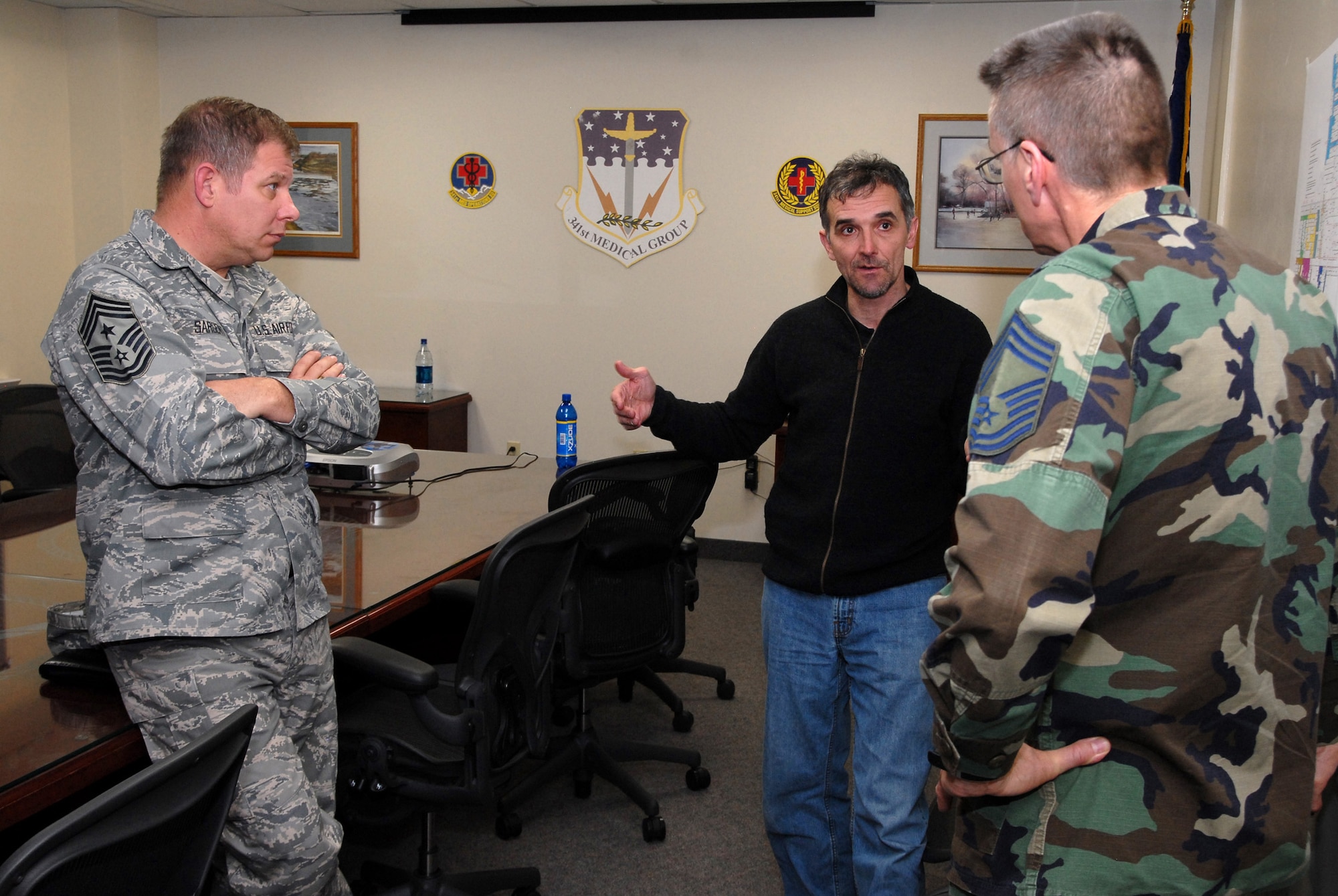 Chief Master Sgt. Steve Sargent, 341st Space Wing command chief, and Chief Master Sgt. Richard Riddle, 341st Medical Group superintendent, speak with John Underwood, president and founder of the American Athletic Institute, following a presentation he gave on the negative physiological effects of alcohol on athletes and Airmen whose motto is “Fit to Fight” April 1. (U.S. Air Force photo/John Turner)