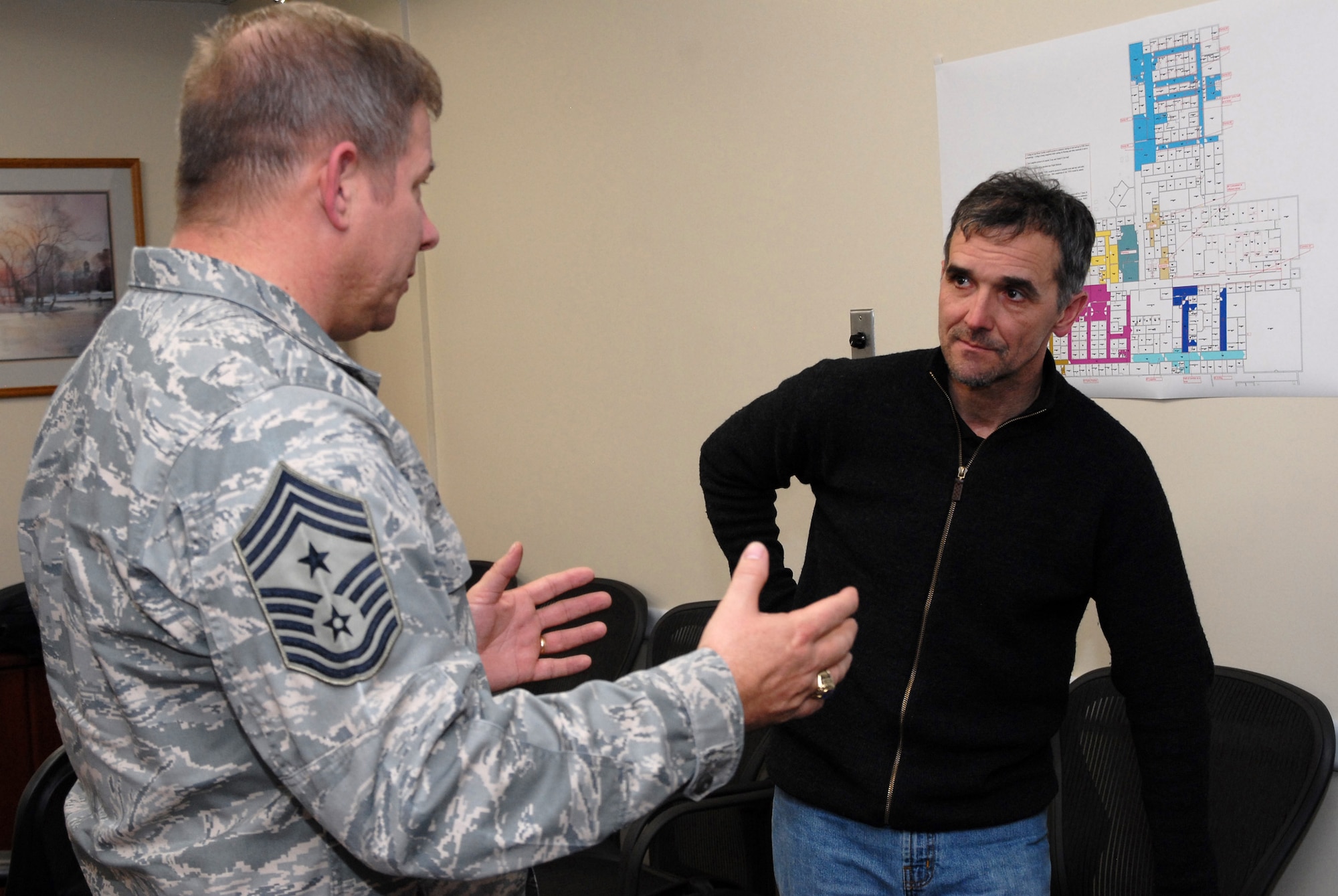 Chief Master Sgt. Steve Sargent, 341st Space Wing command chief, speaks with John Underwood, president and founder of the American Athletic Institute, following a presentation he gave on the negative physiological effects of alcohol on athletes and Airmen whose motto is “Fit to Fight” April 1. (U.S. Air Force photo/John Turner)