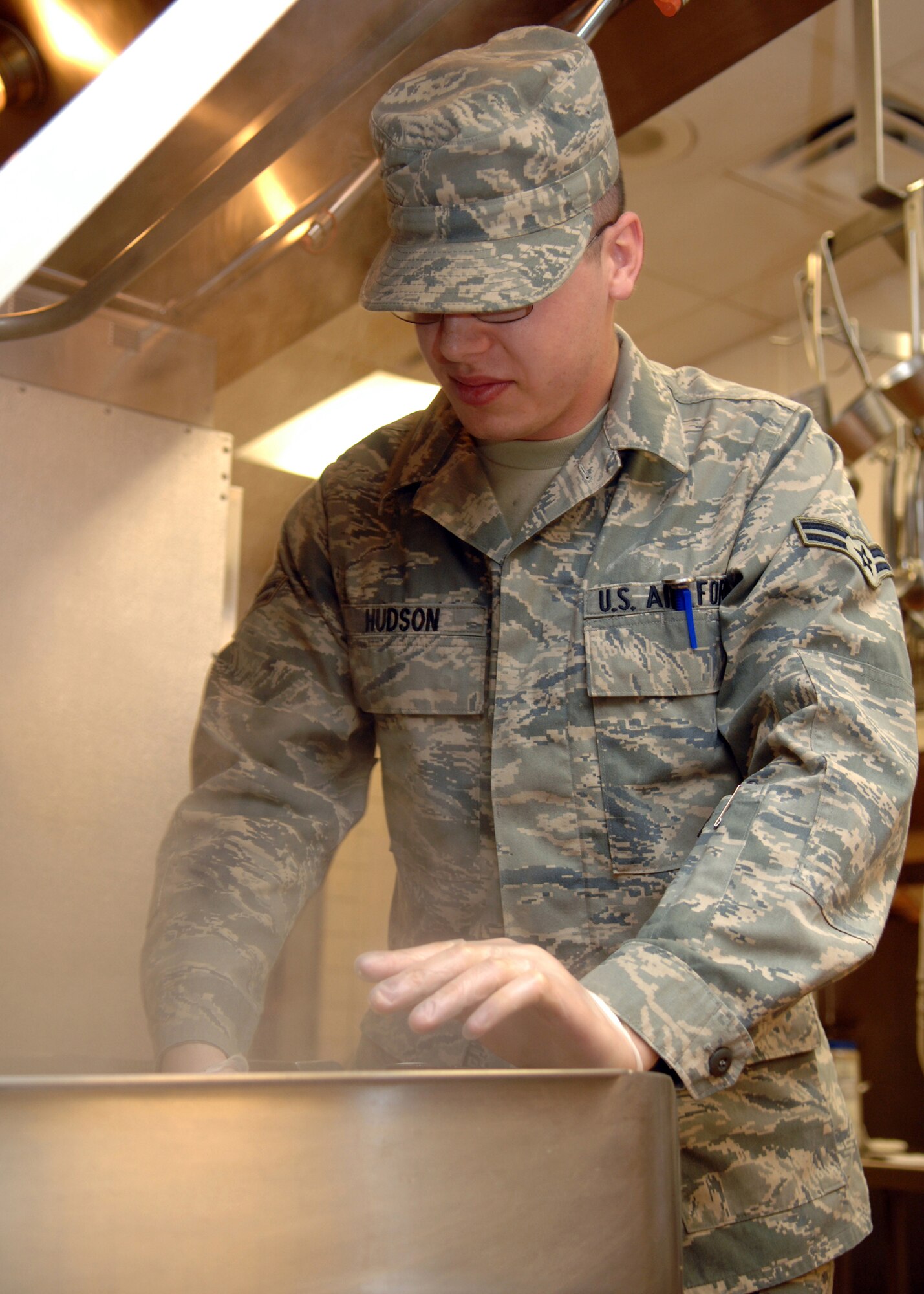 HOLLOMAN AIR FORCE BASE; N.M. -- Airman 1st Class Zackary Hudson, 49th Service Squadron, prepares chicken fajitas for the quarterly birthday party in the kitchen of the Shifting Sands Dining Facility here March 18. (U.S. Air Force photo by Airman Sondra M. Wieseler)