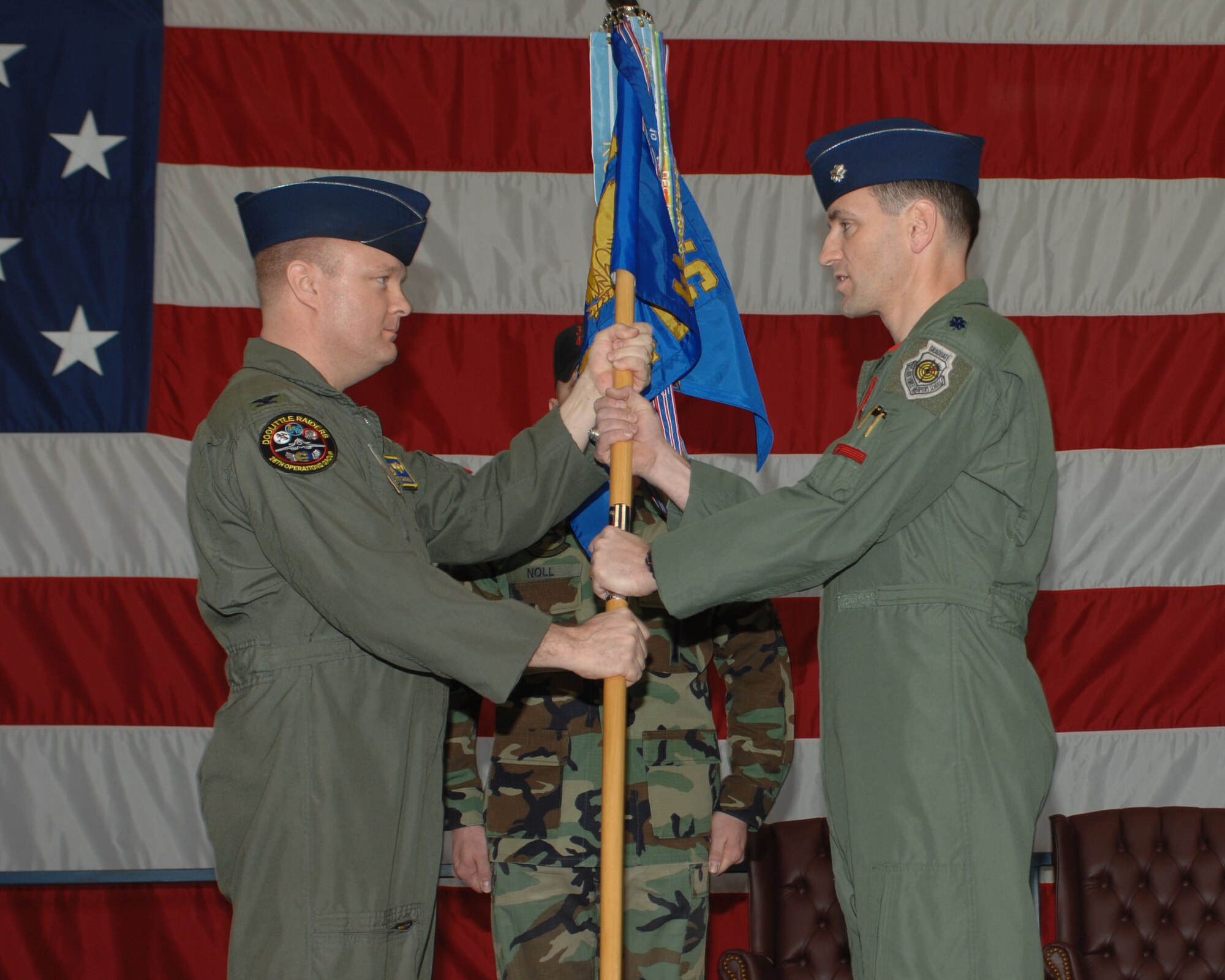 (Right to left) Lt. Col. Kevin Kennedy, incoming 34th Bomb Squadron commander, receives the guidon from Col. "Buck" Shawhan, 28th Operations Group commander, during a change of command ceremony April 4. By receiving the giudon, Colonel Kennedy accepts command of the 34th Bomb Squadron. (U.S. Air Force photo/Airman 1st Class Joshua Seybert)
