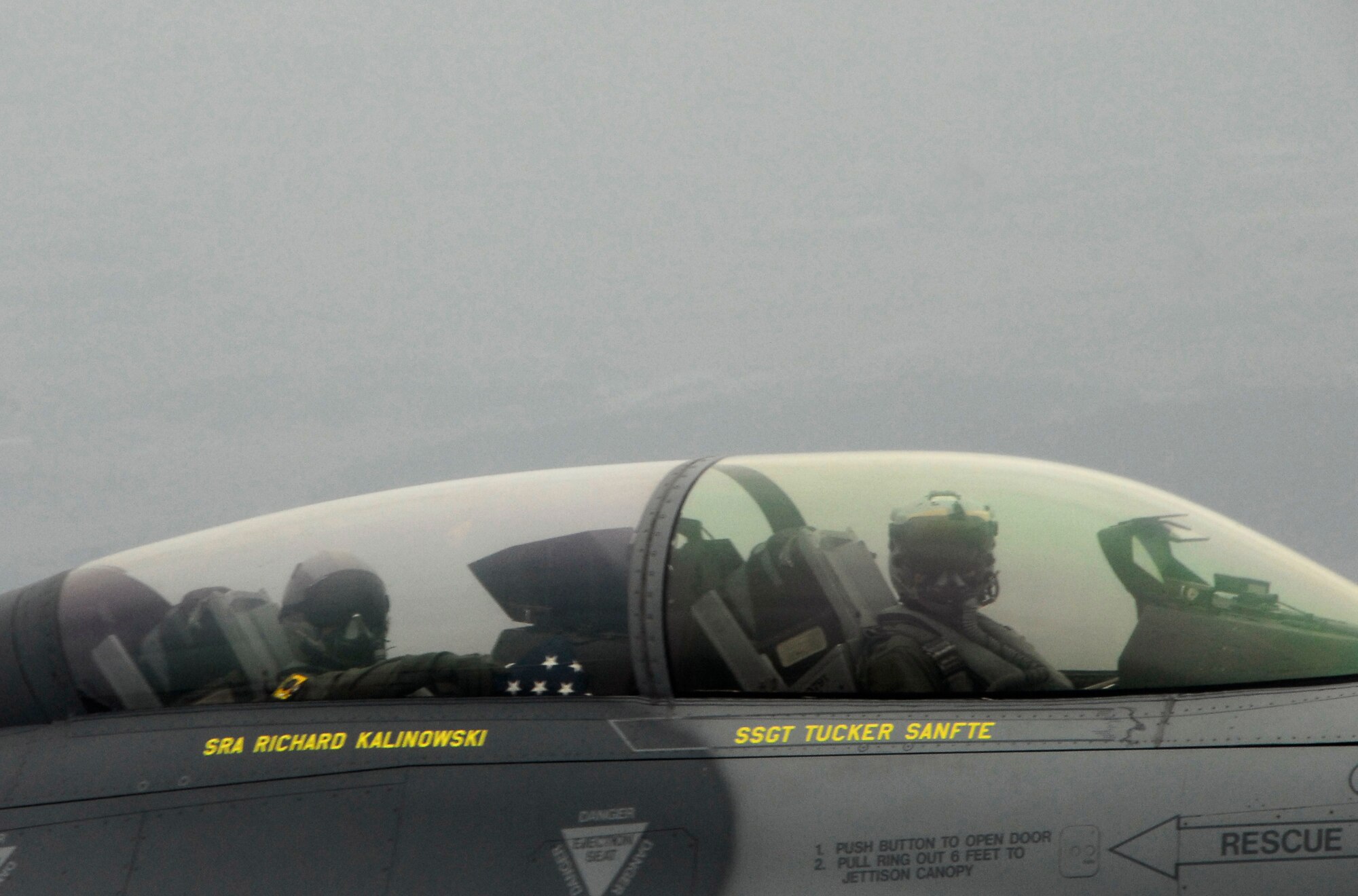 KUNSAN AIR BASE, Republic of Korea -- Colonel Kenneth Rizer, 8th Operations Group Commander, administers the oath of reenlistment to Staff Sgt. Robert Martin, 8th Aircraft Maintenance Squadron crew chief, during an F-16 incentive flight over the peninsula April 9. (U.S. Air Force photo/Tech. Sgt. Quinton T. Burris)  