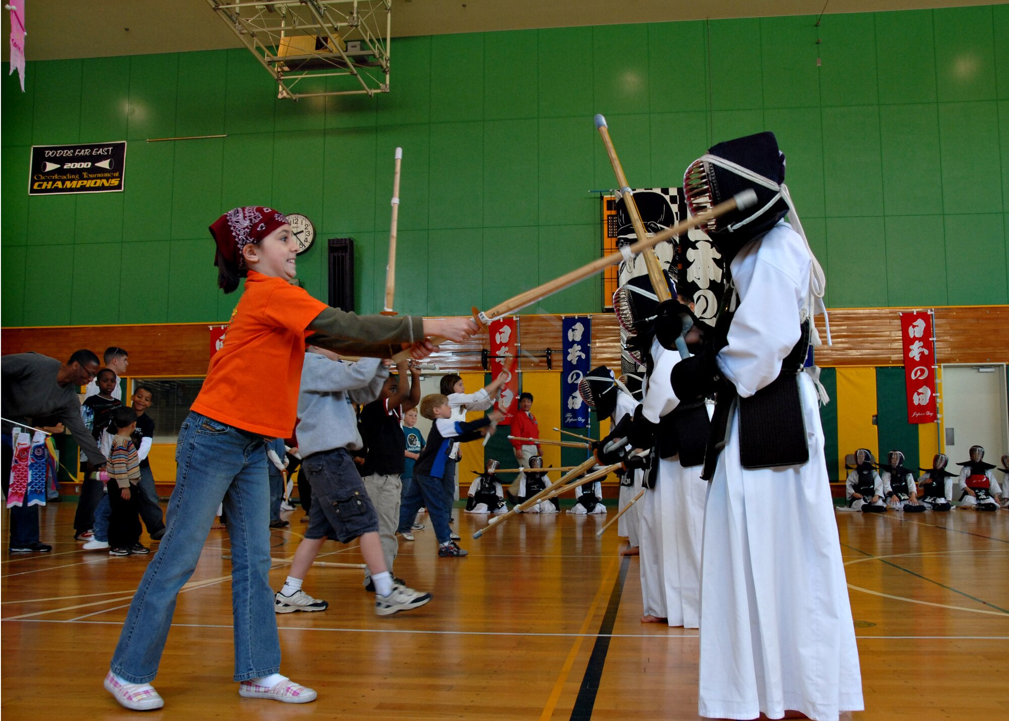 MISAWA AIR BASE, Japan – American children try their hand at Kendo, the Japanese martial art of fencing, with Japanese Kendo students during Japan Day here April 5, 2008. Kendo is practiced wearing traditionally styled clothing and protective armor, as seen on the Japanese students, using one or two bamboo swords. (U.S. Air Force photo by Staff Sgt. Rachel Martinez)