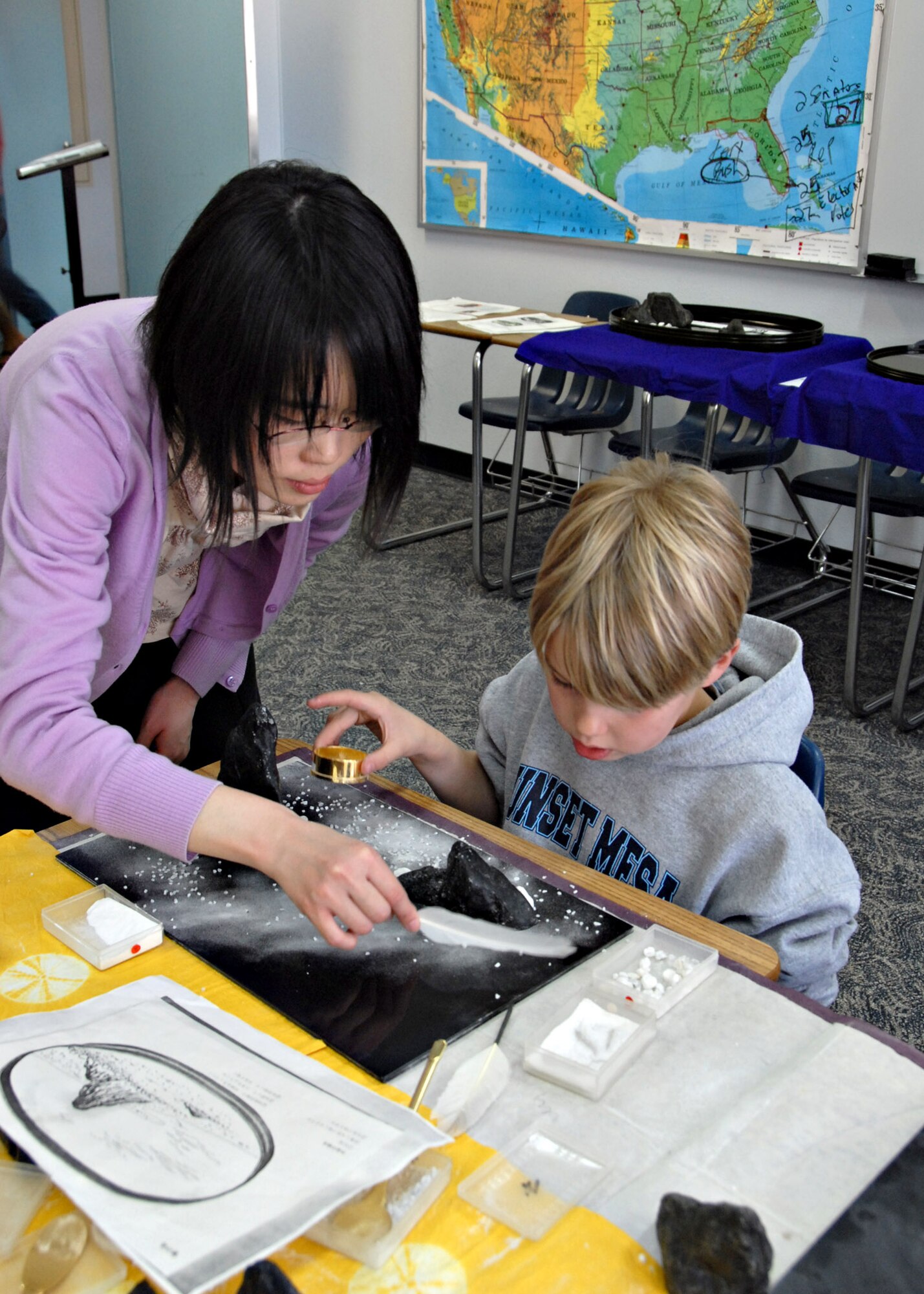 MISAWA AIR BASE, Japan – Talmage Harris, 8 years old, is shown by a Japanese artisan how to create a sand art landscape during Japan Day here April 5, 2008. Sand art was just one of the 25 cultural displays held in the Edgren High School classrooms. (U.S. Air Force photo by Staff Sgt. Rachel Martinez)