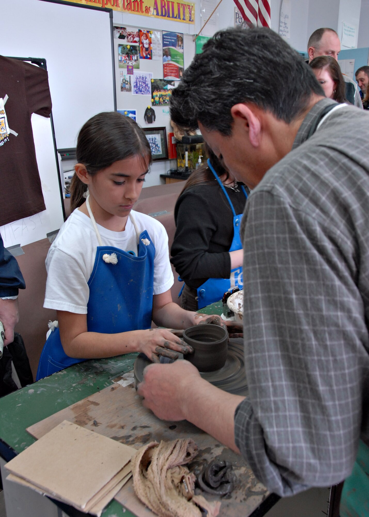 MISAWA AIR BASE, Japan – Ashley Johnson, age 9, is assisted by a Japanese artisan while making a pot during the Misawa Toin pottery making class at Japan Day here April 5, 2008. In addition to making pots, children were able to press images of popular cartoon characters into clay. (U.S. Air Force photo by Staff Sgt. Rachel Martinez)