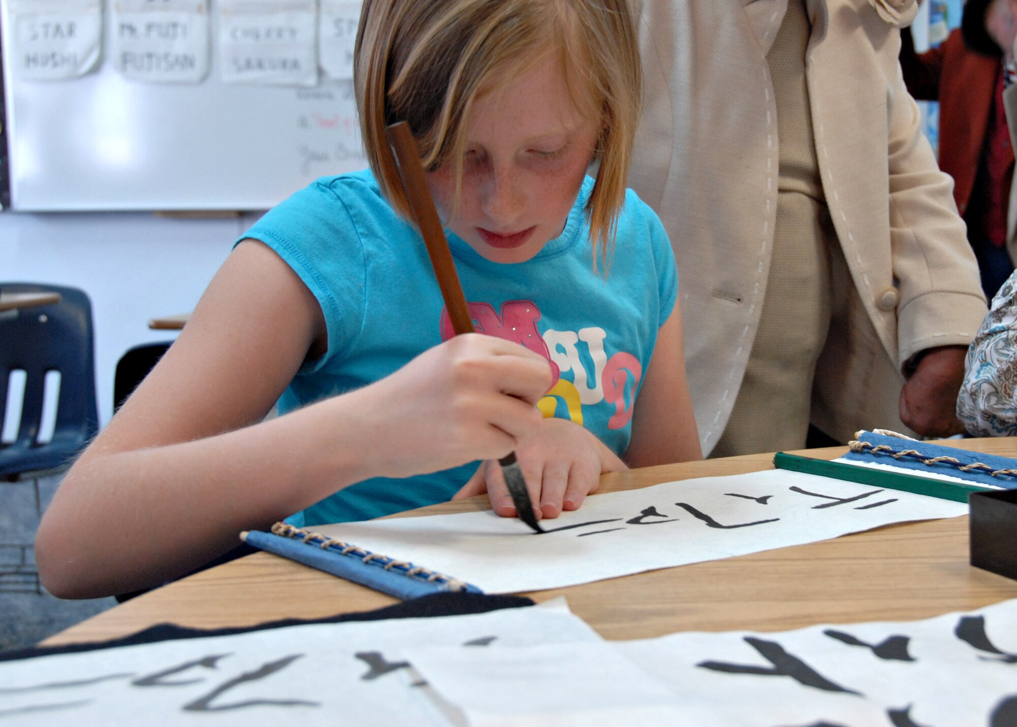 MISAWA AIR BASE, Japan – Tiffany Friedline, age 10, writes her name on a scroll during the Taigaku Calligraphy class at Japan Day here April 5, 2008. Participants were shown how to write their name in Katakana. (U.S. Air Force photo by Staff Sgt. Rachel Martinez)